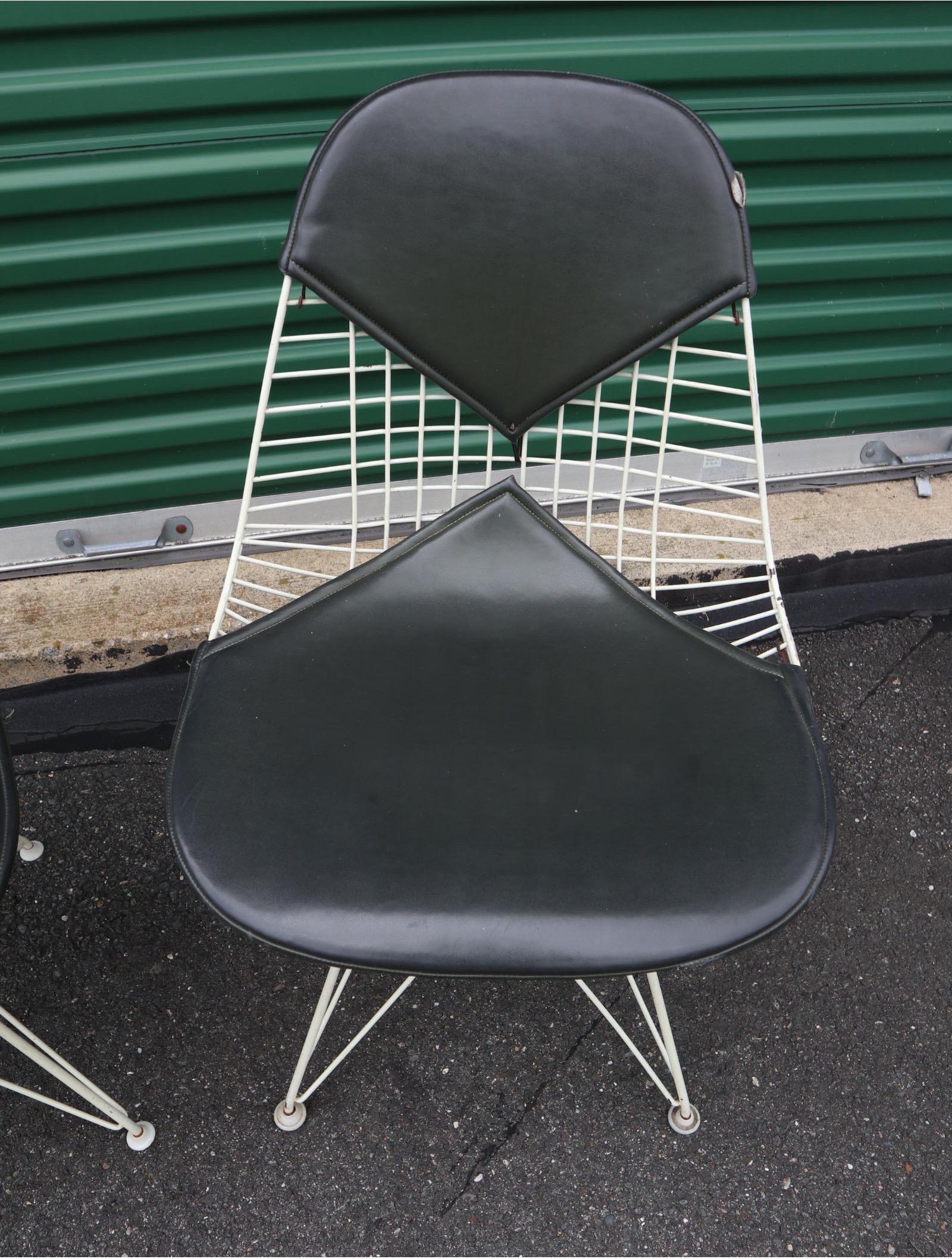 Pair of original Eames DKR-2 Bikini Wore chairs for Herman Miller. Normal wear with great color. These fairer the less common but more attractive wire shells and Eiffel bases with black Naugahyde pads. Signed and guaranteed authentic. Ships