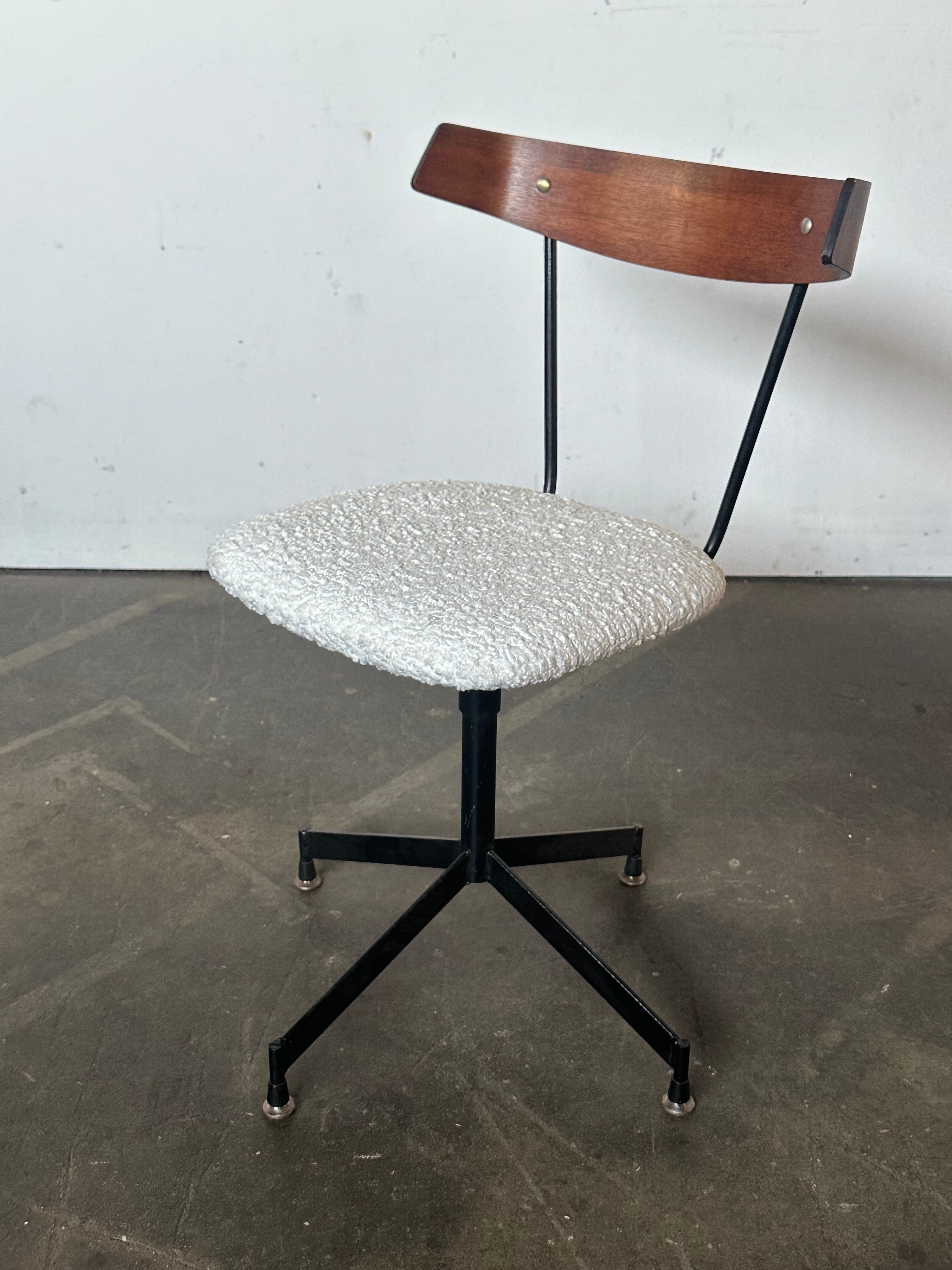 Beautiful swiveling office/desk chair designed by Clifford Pascoe and produced by Modern Masters Inc. curved wooden back on iron frame. Seat cushion reupholstered in boucle. Chair swivels freely. Wood cleaned and oiled. Presents very well. Add some