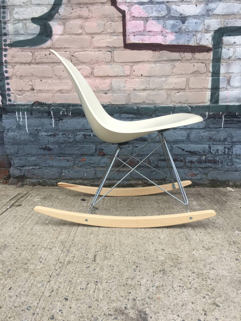 Perfect Herman Miller Eames rocketing chair. Vintage parchment shell on new maple and steel base. Signed Herman Miller.