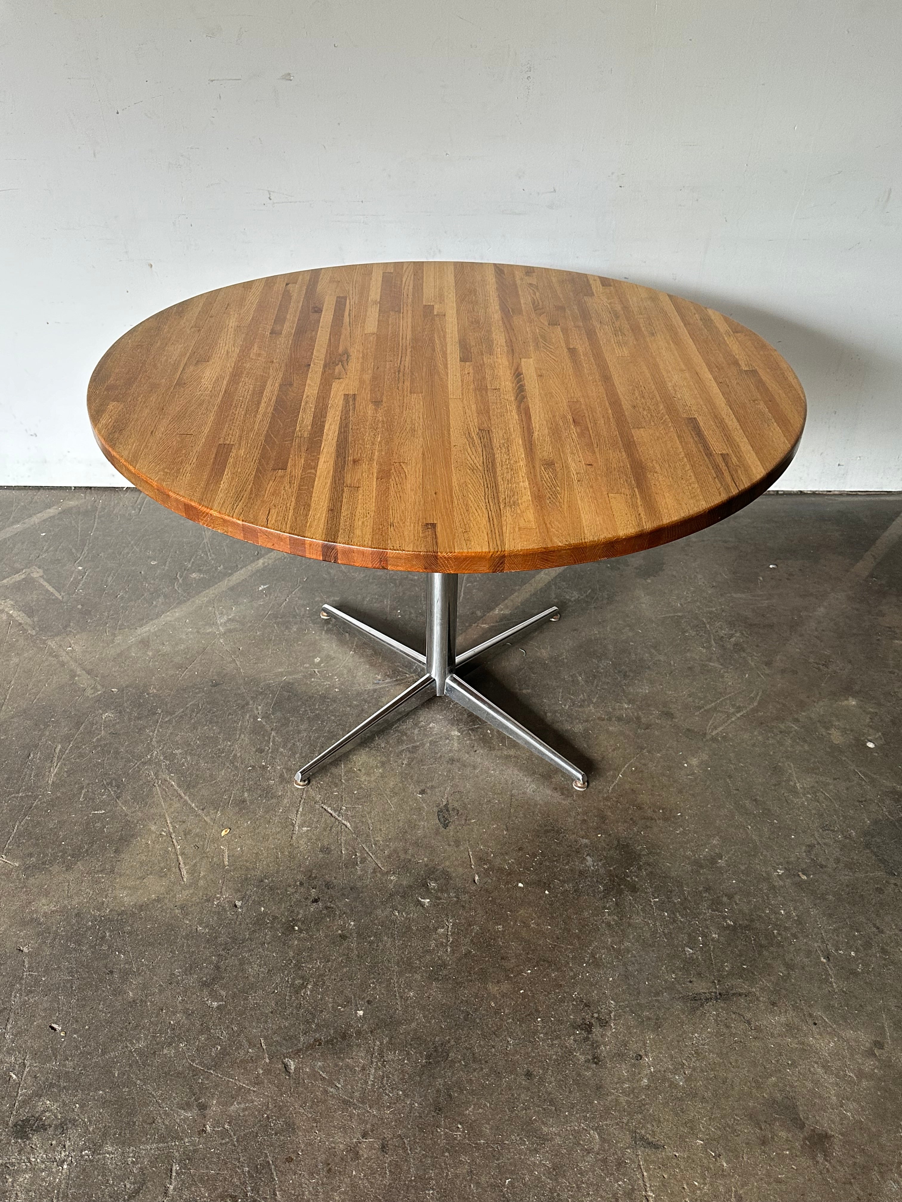 48” diameter round dining table. Elegant and efficient silhouette. Handsome as the main dining table in an apartment or also perfect as a kitchen table. Can easily seat 4-5 dining chairs. In good condition with a tasteful refresh. Solid 1.25”