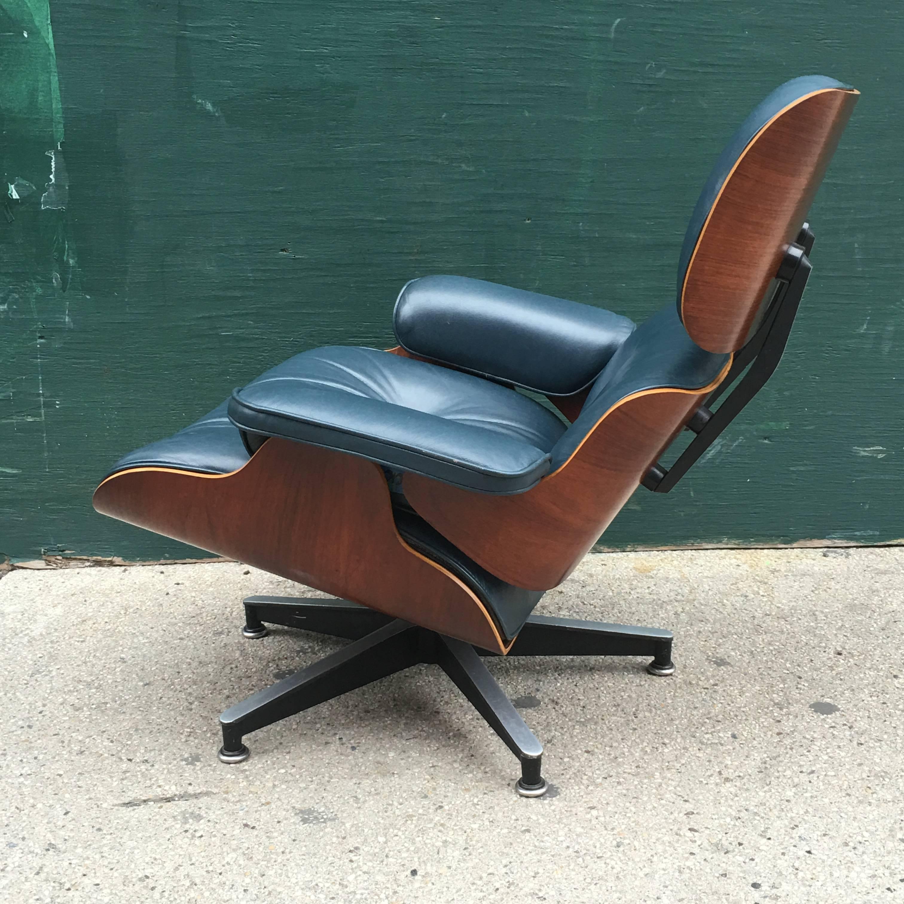 Rosewood Eames lounge chair in rare navy leather. Purchased from original owner. 1970s chair. New shock mounts. No cracking or tears in leather.