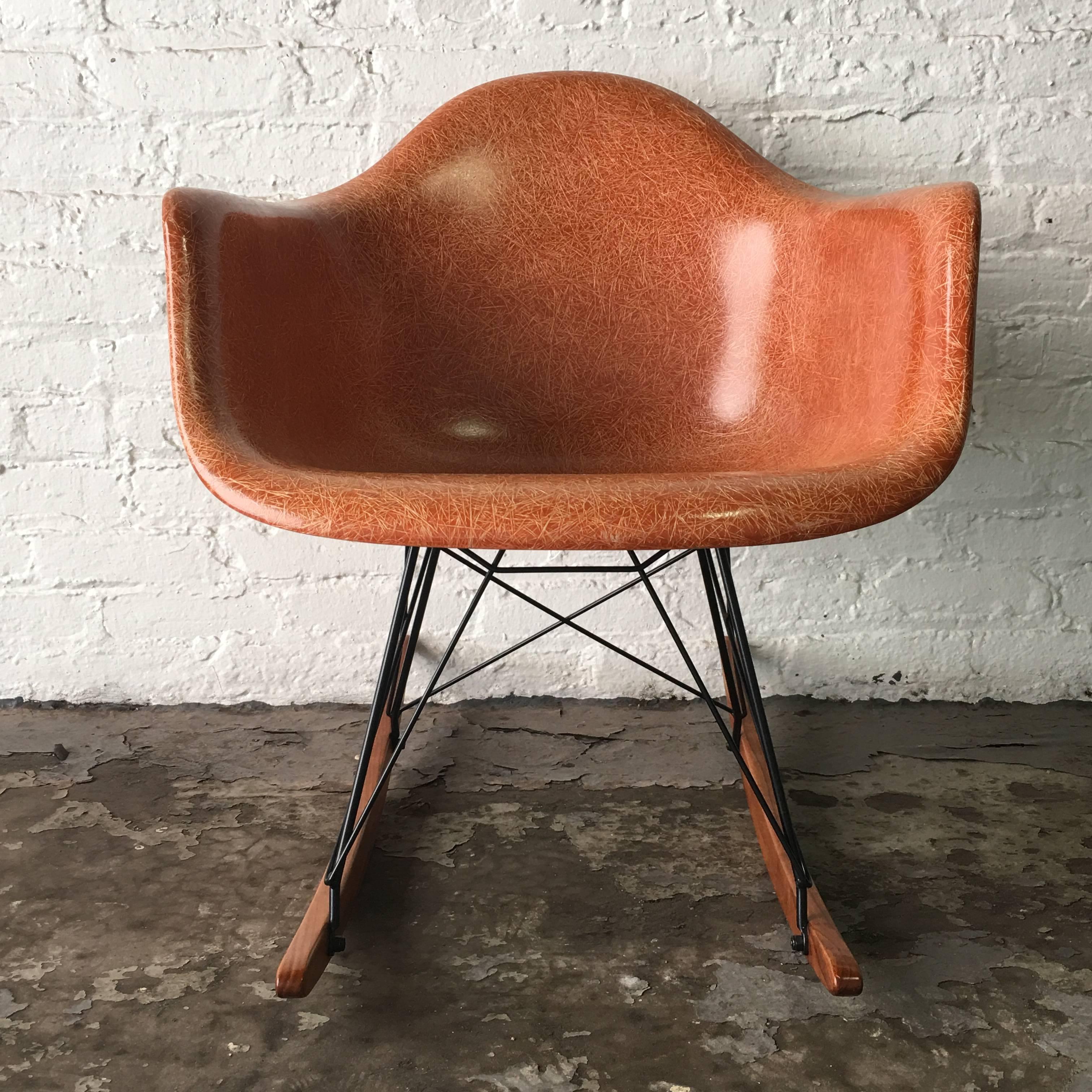Rare color terra cotta Herman Miler Eames arm shell on Modern Conscience base. Base also available in zinc plating (Silver) and also wood available in maple or birch. Shell in very good vintage condition with no fading or cracks. Small spot of edge