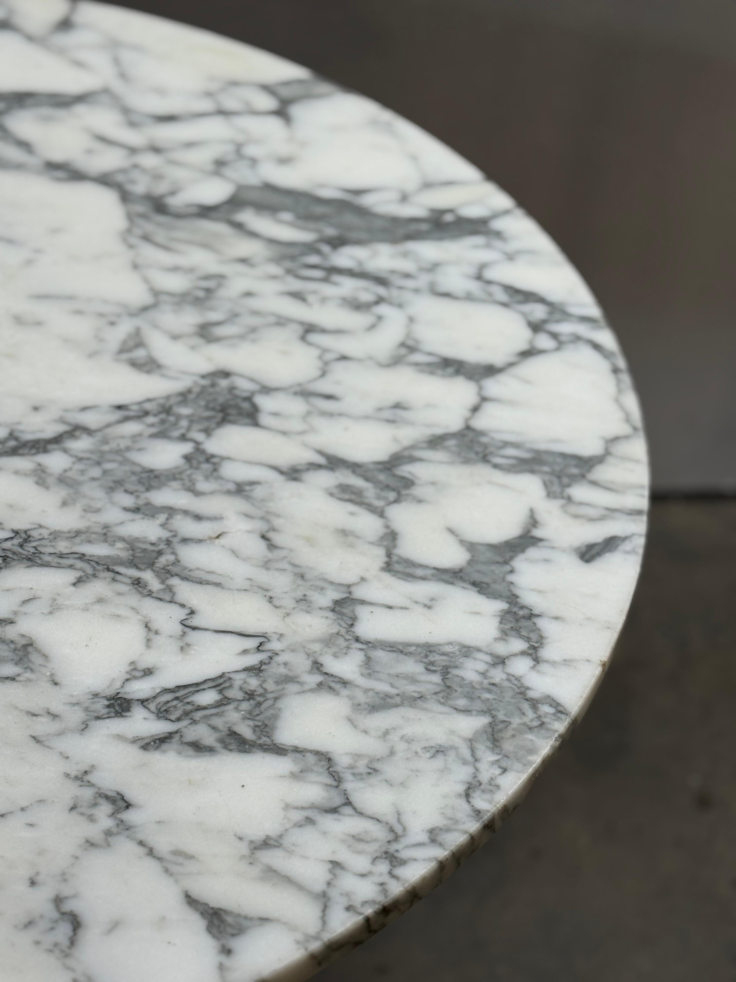 Gorgeous dining table featuring cast aluminum Herman Miller contract base paired with Italian calacatta marble top. Both pieces date to the mid 20th century. The underside of the marble slab is stamped Made in Italy. The pedestal has been refreshed