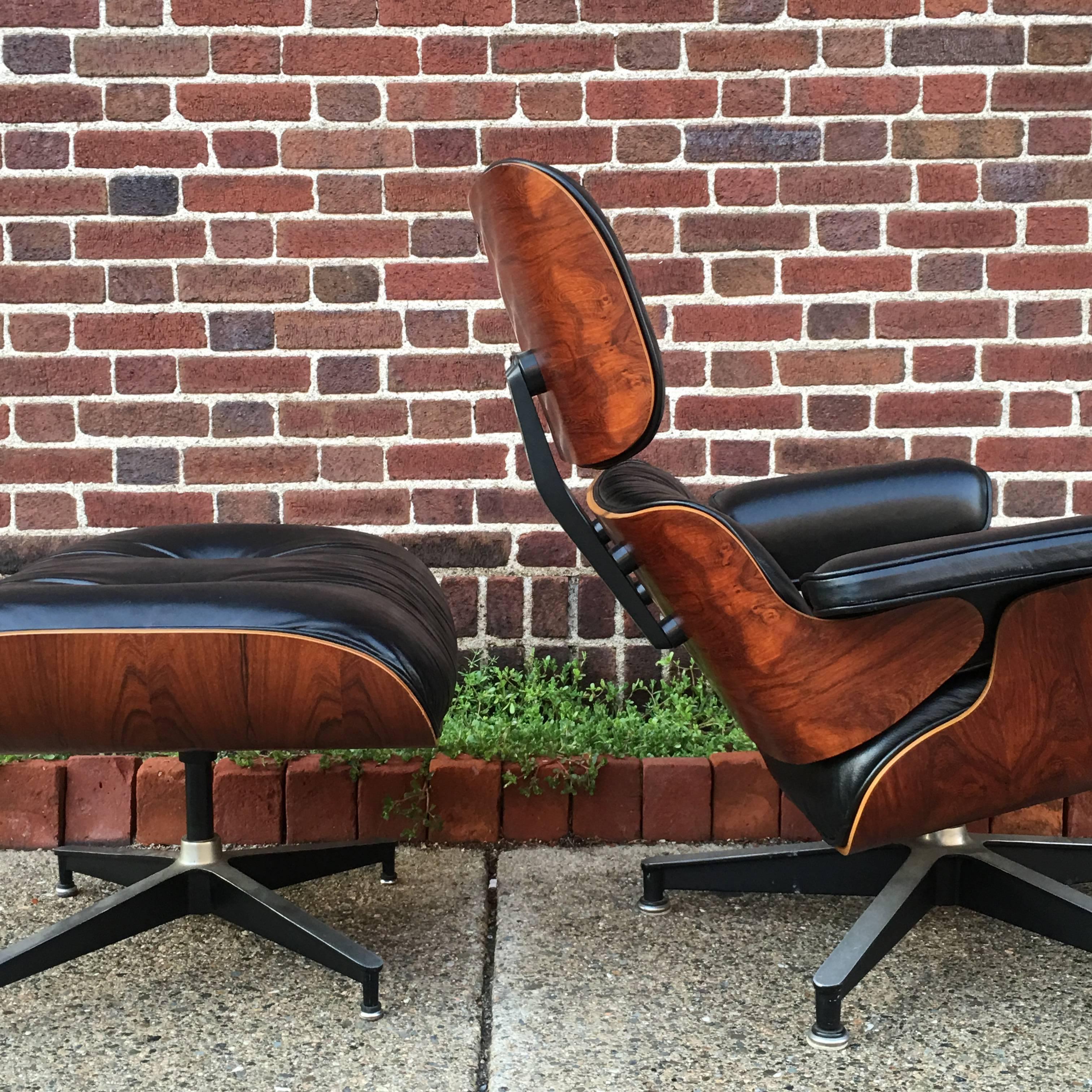 1970s Herman Miller Eames lounge with dramatic and highly figured rosewood panels. Amazing depth of color and contrast with no bleaching or damage. Original black cushions. Leather in very good condition with minor wear but no cracks. Chair is all