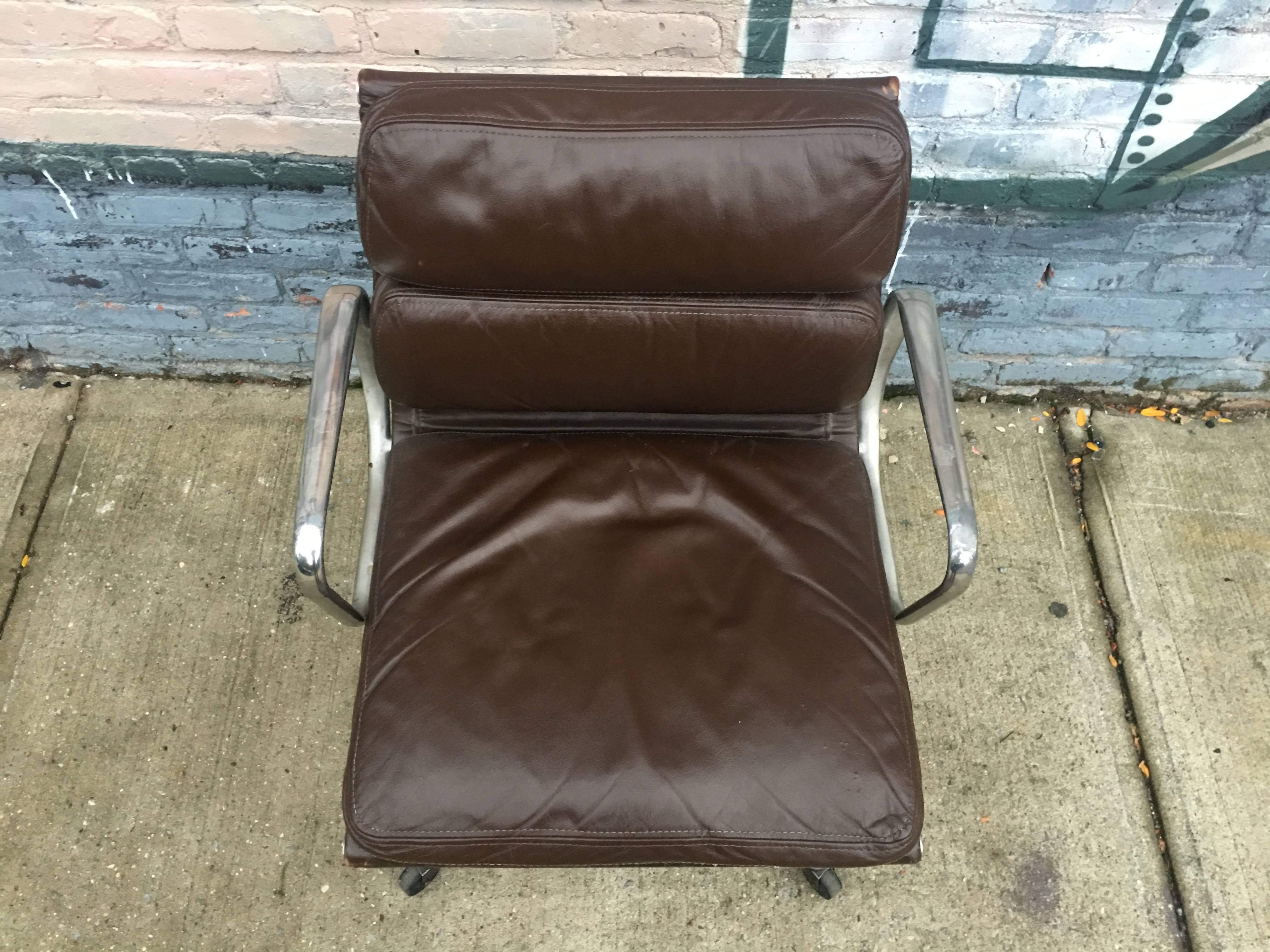 1970s Herman Miller Eames soft pad management chair. Brown supple leather is superb condition. Normal wear, including rubbing on armrests. All original and signed.