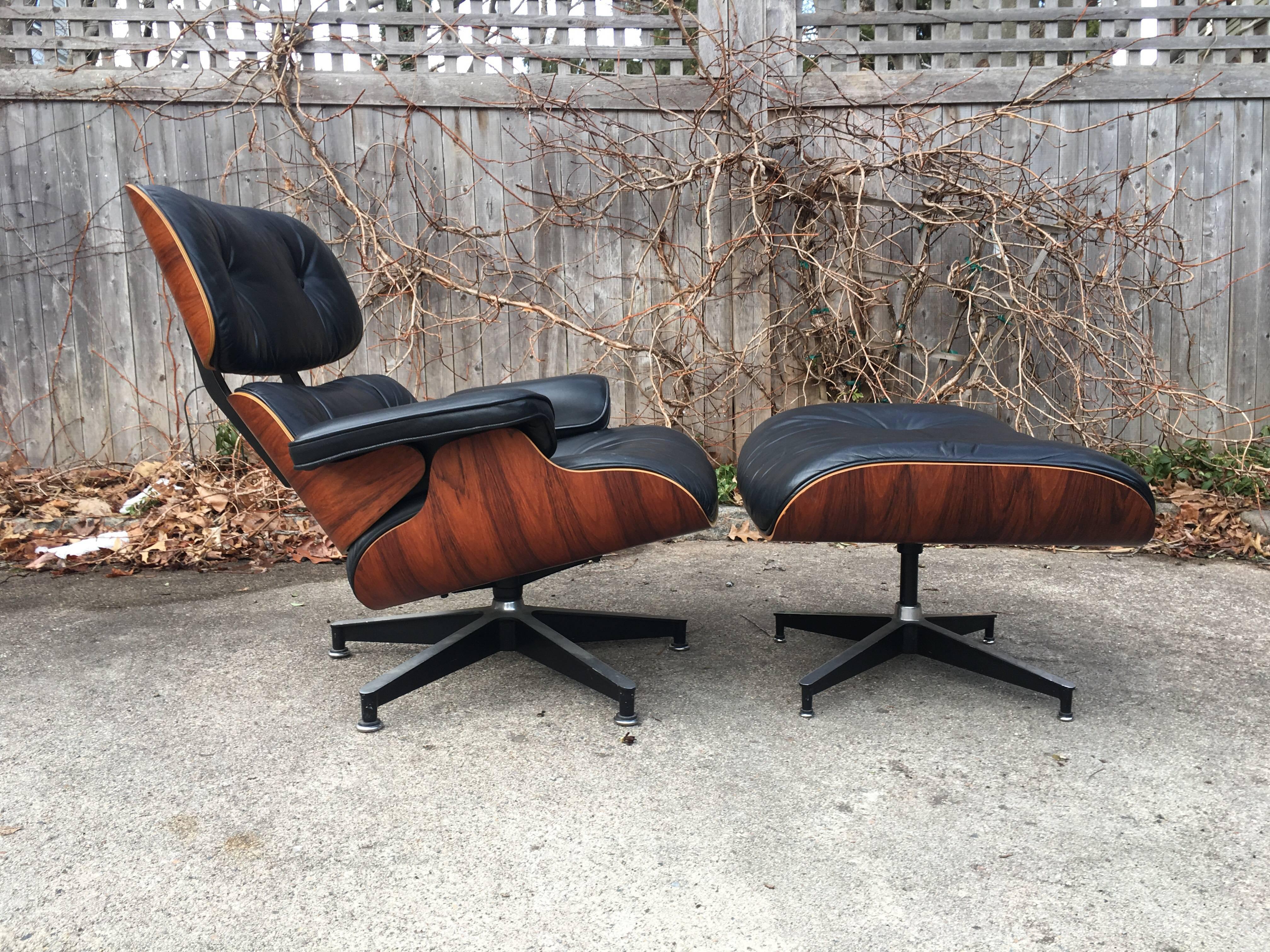 Perfect 1970s Herman Miller Eames lounge chair and ottoman in rosewood. Spectacular rosewood grains and color. All original.