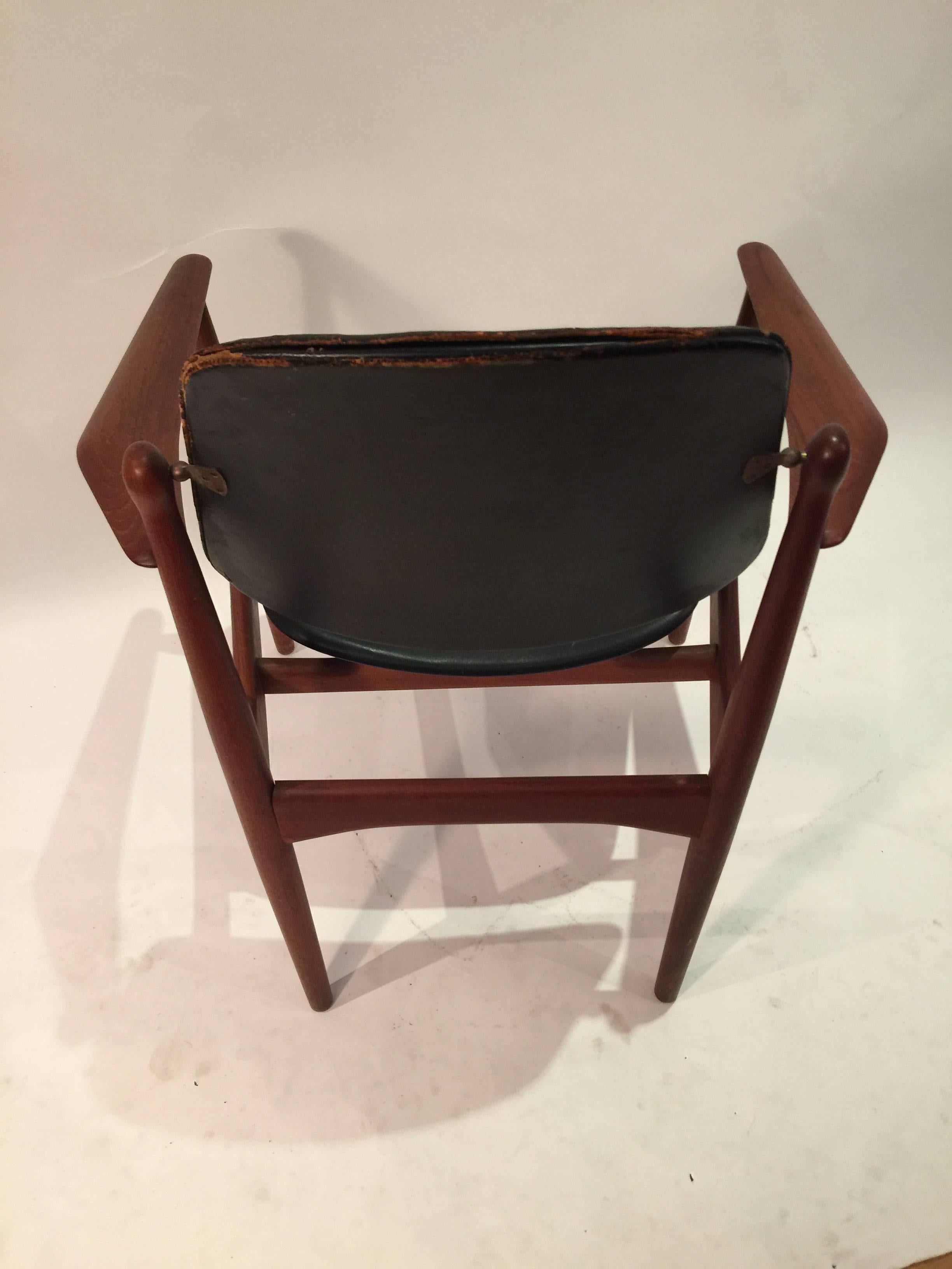 Arne Vodder design armchair model FD-184 made by France & Daverksen. Seat and back covered in original black leather. The swivel back hardware is made of brass. Leather is heavily distressed and missing some stitches to the back and loss to the