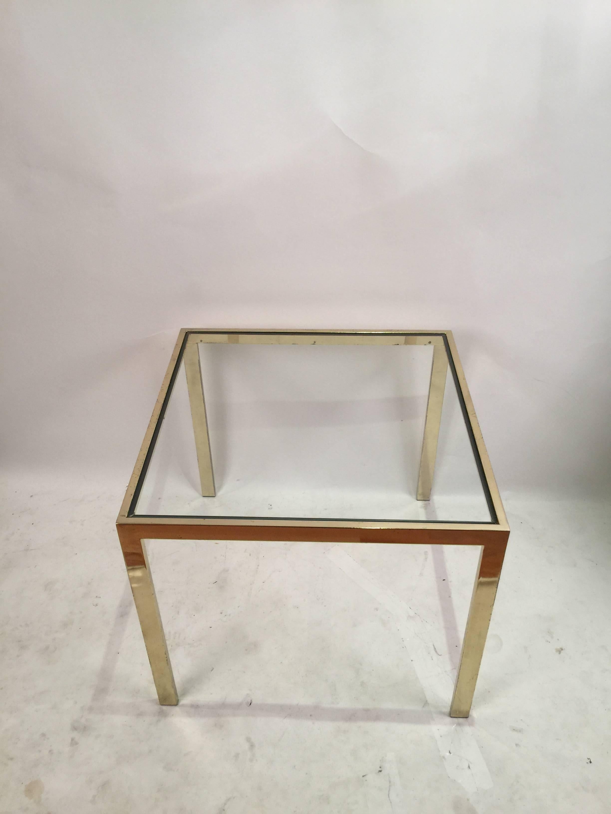 Classic brass and glass square table. This 'Flat Bar' design was produced by the Design Institute of America in 1986.
  