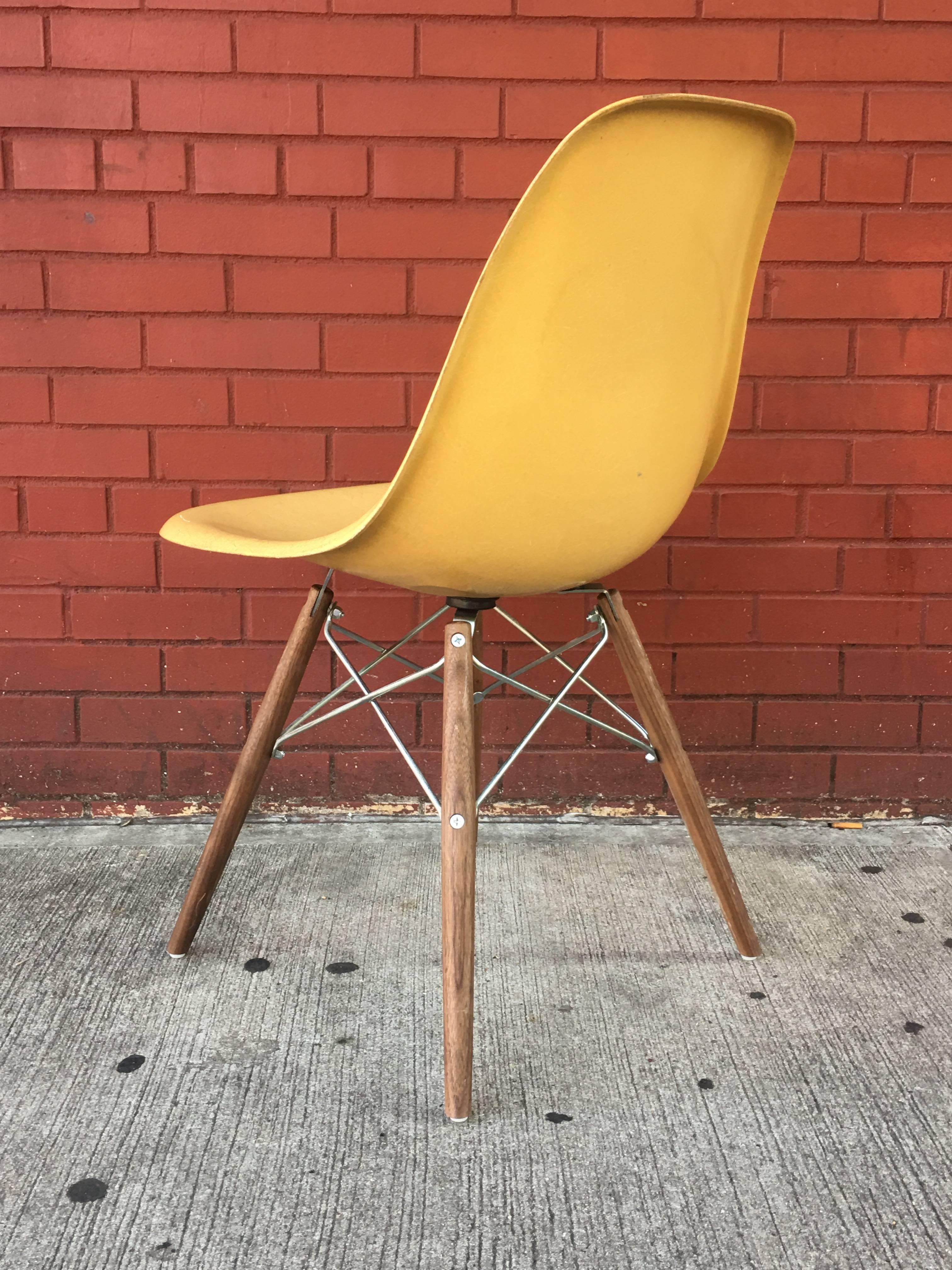 Ten Herman Miller Eames dining chairs in Ochre light. New walnut stained bases with black metal (base pictured in individual photo).