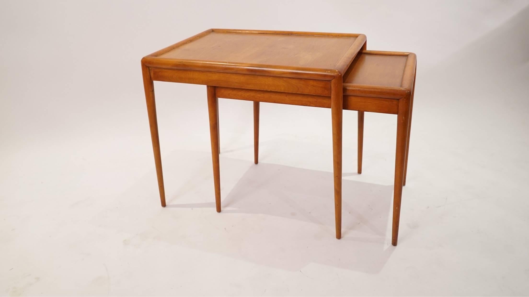 A beautiful pair of Model No. 1783 Mid-Century nesting tables by American designer T.H. Robsjohn Gibbins. This set is an early 1952 production for Widdicomb. The set is in fair vintage condition. Some minor losses to the finish and some