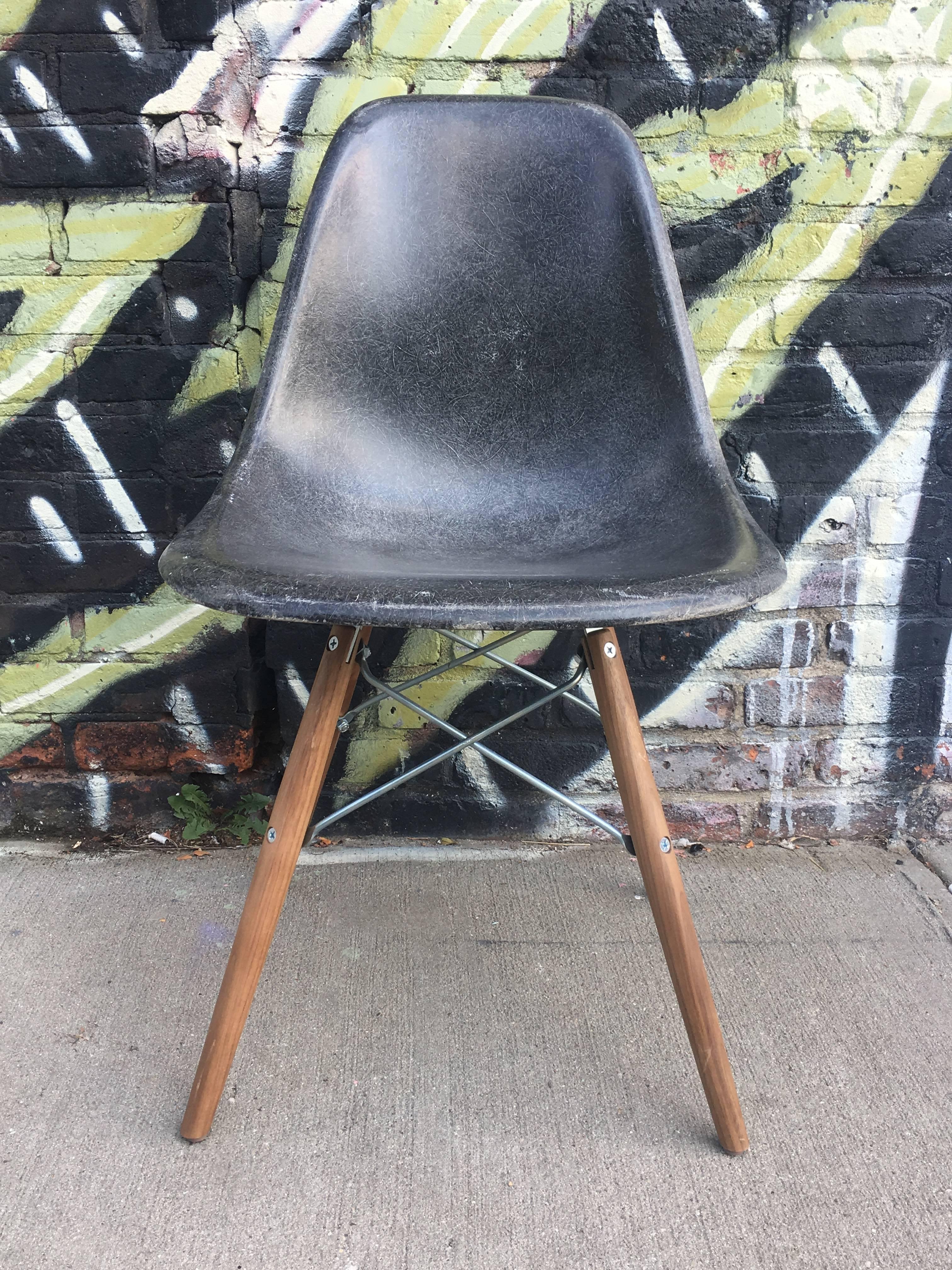 4 multicolored Herman Miller Eames dining chairs. New walnut or maple stain bases. Green shell has grey back, grey shell has tan back.