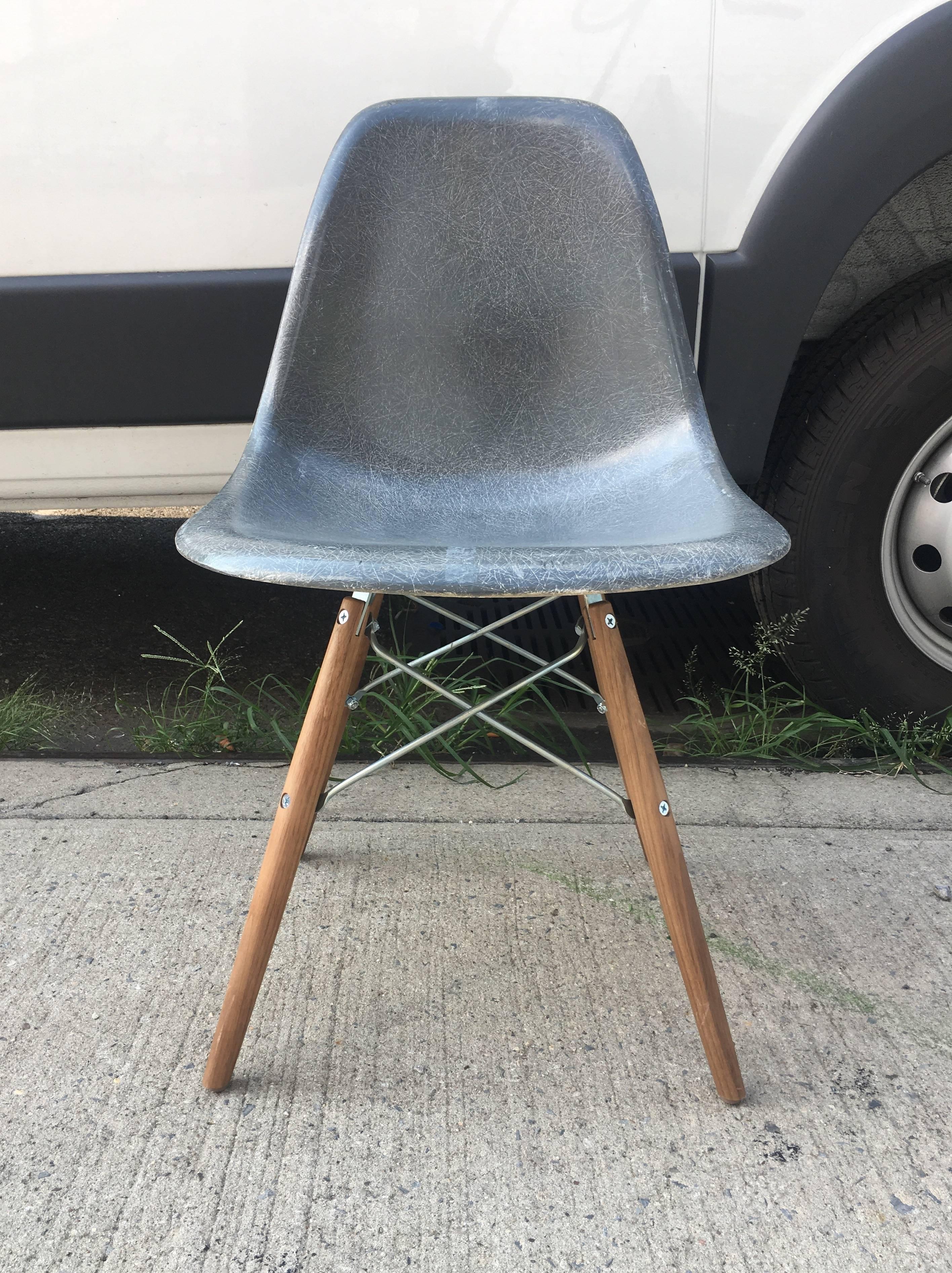 Set of eight Eames dining chairs. Four in navy and four in elephant grey. New walnut bases. In excellent condition. Ships disassembled.