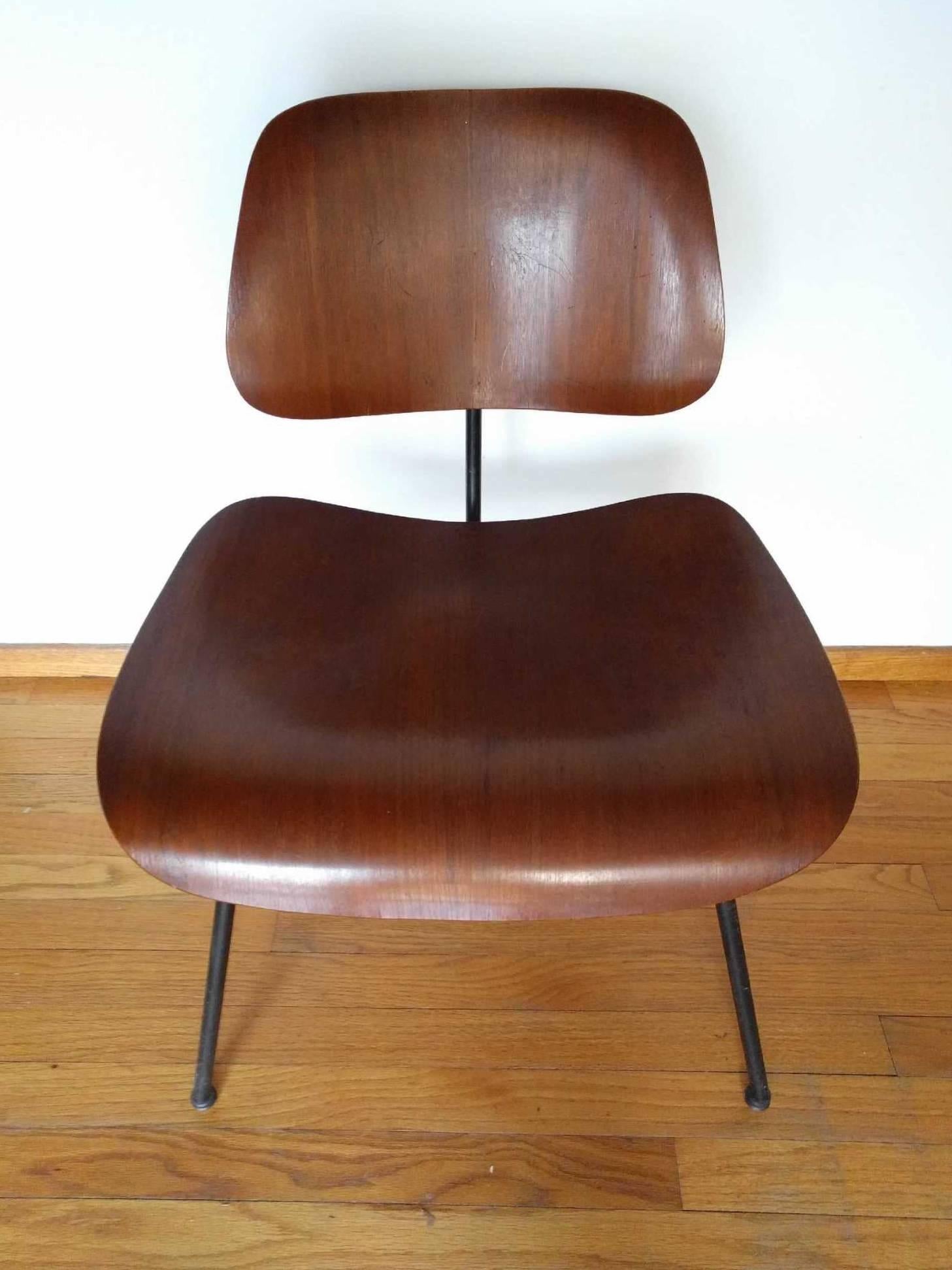All original early Herman Miller Eames DCM chair in walnut. Marked 1951. Gorgeous patina and black iron base. Original mounts and glides.