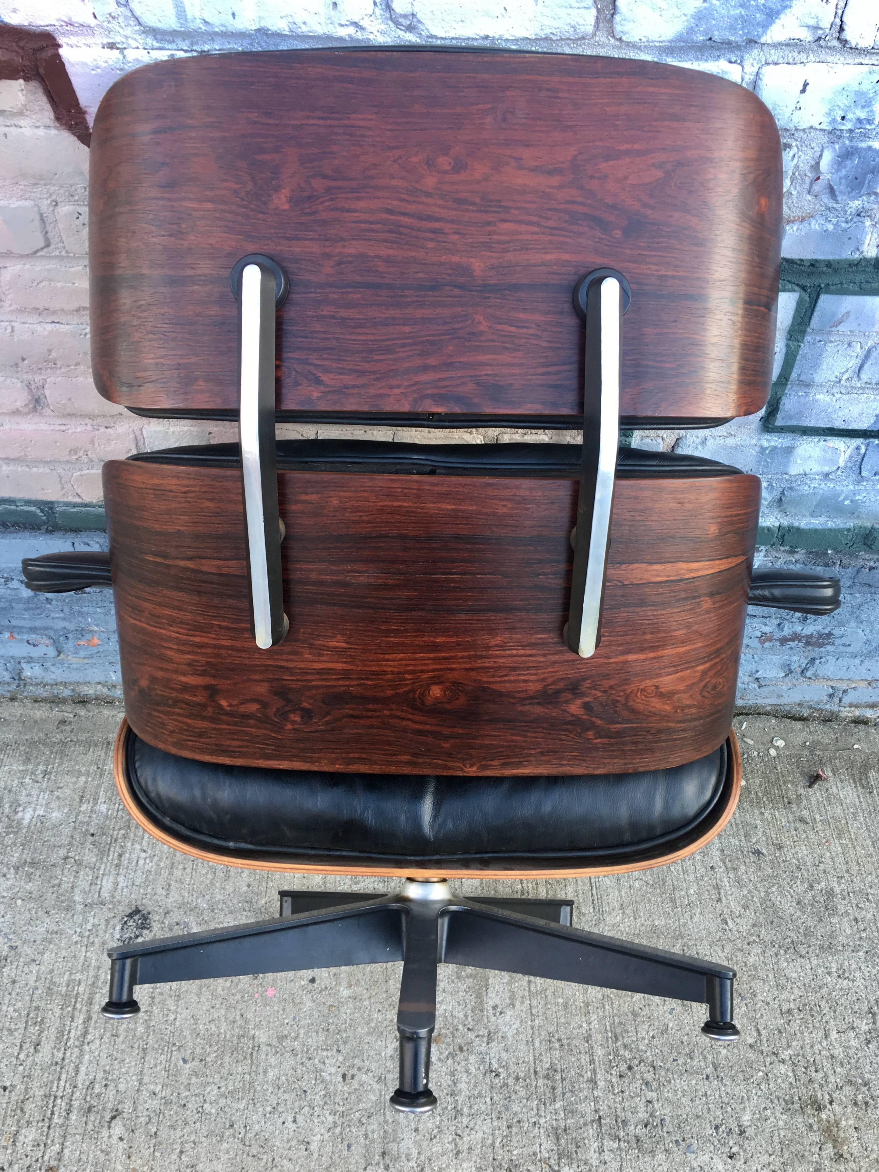 Early 1960s Down Filled Herman Miller Eames lounge chair and ottoman. All original in very good condition for a piece this age. Gorgeous deep rosewood grains and color. Original chair and ottoman. All original parts.