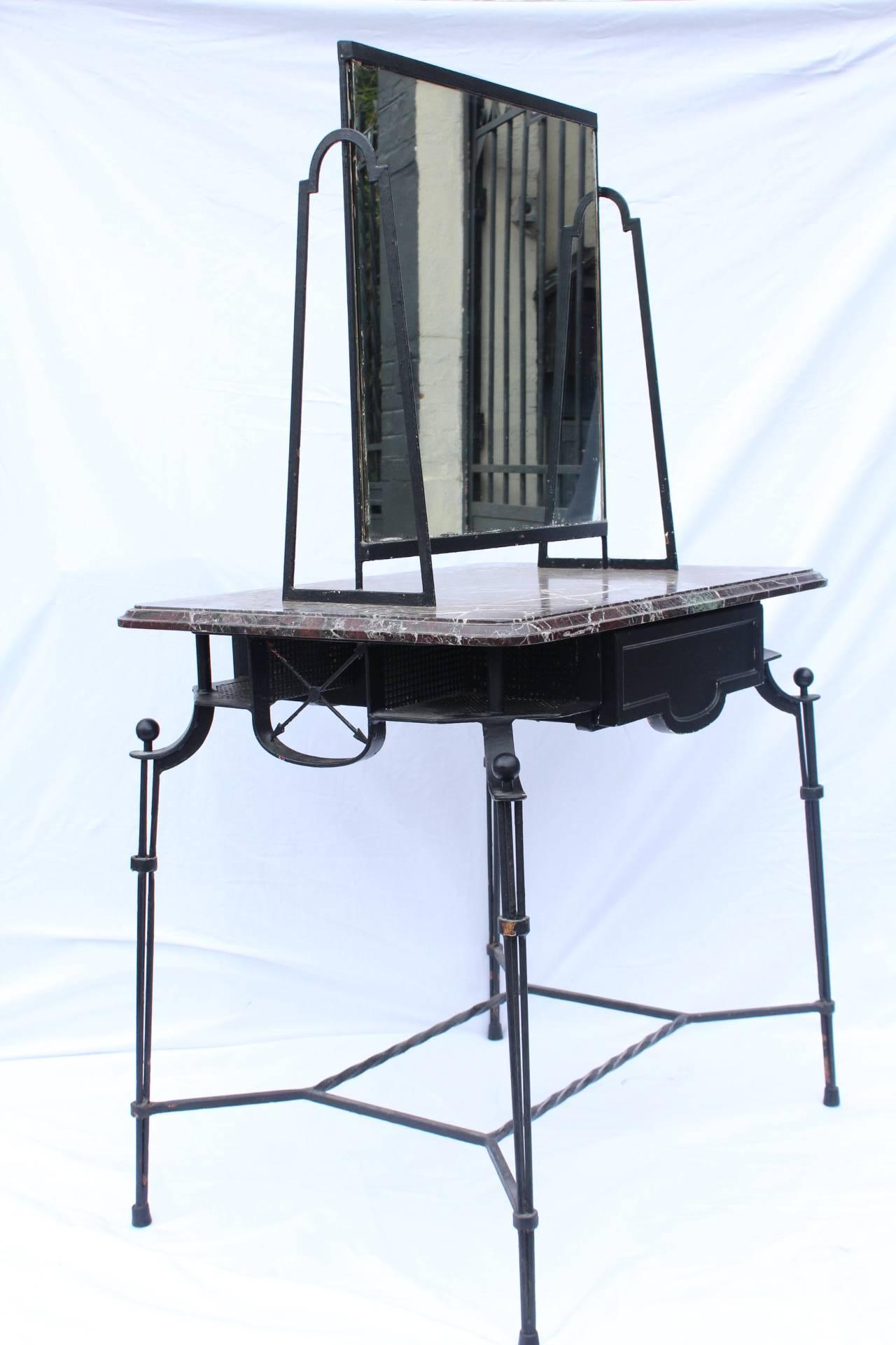 This double-sided hairdresser was made in France during the 1940's. 
The work on the metal and the decorative details, such as the arrows and the design of the base are very fine and typical from the period. The marble gives an elegant touch. 
A