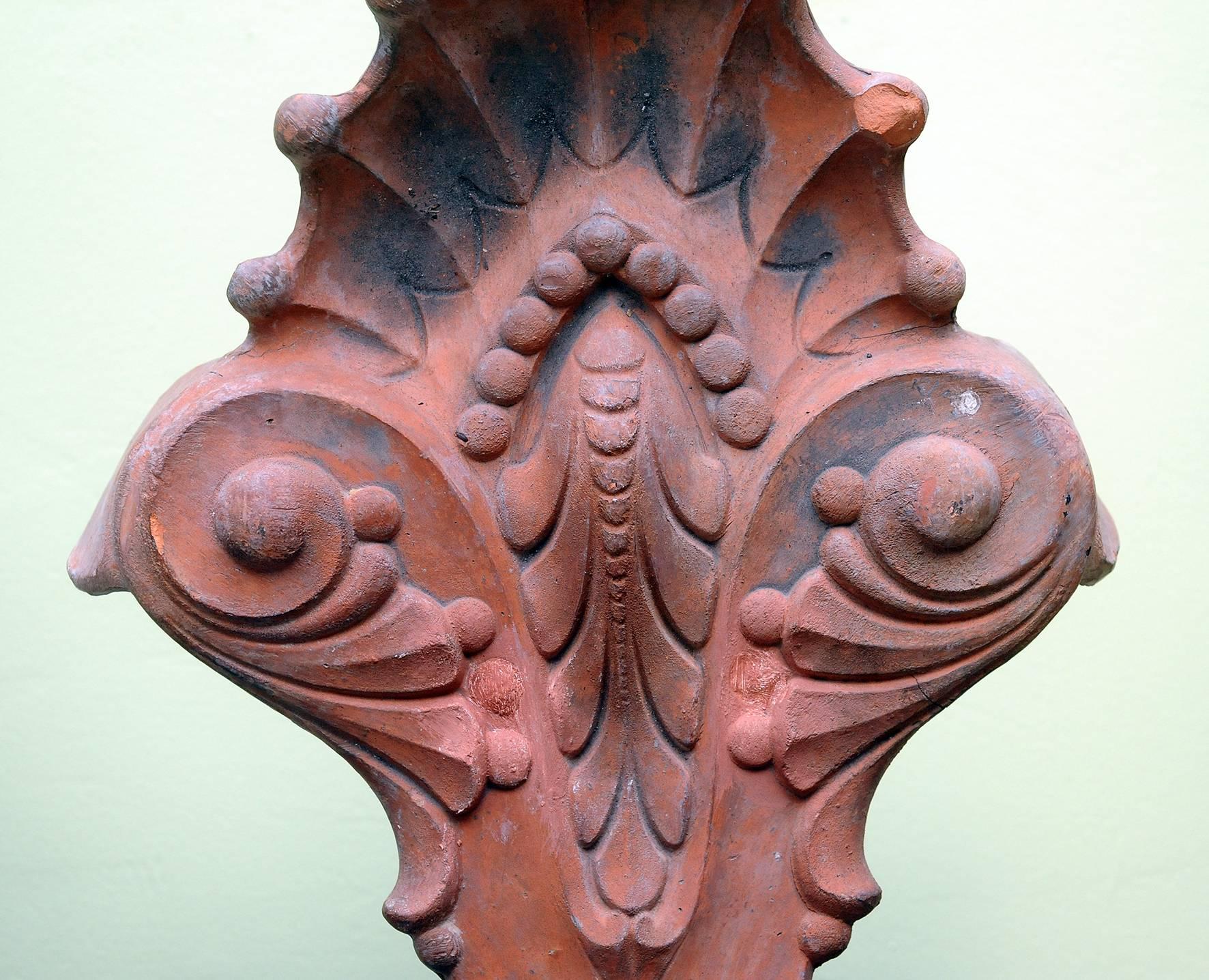 Pair of impressive designed ridge tiles mounted as a lamp,
terra cotta,
1900. 
Mounted on platinum.
One minor accident on top.