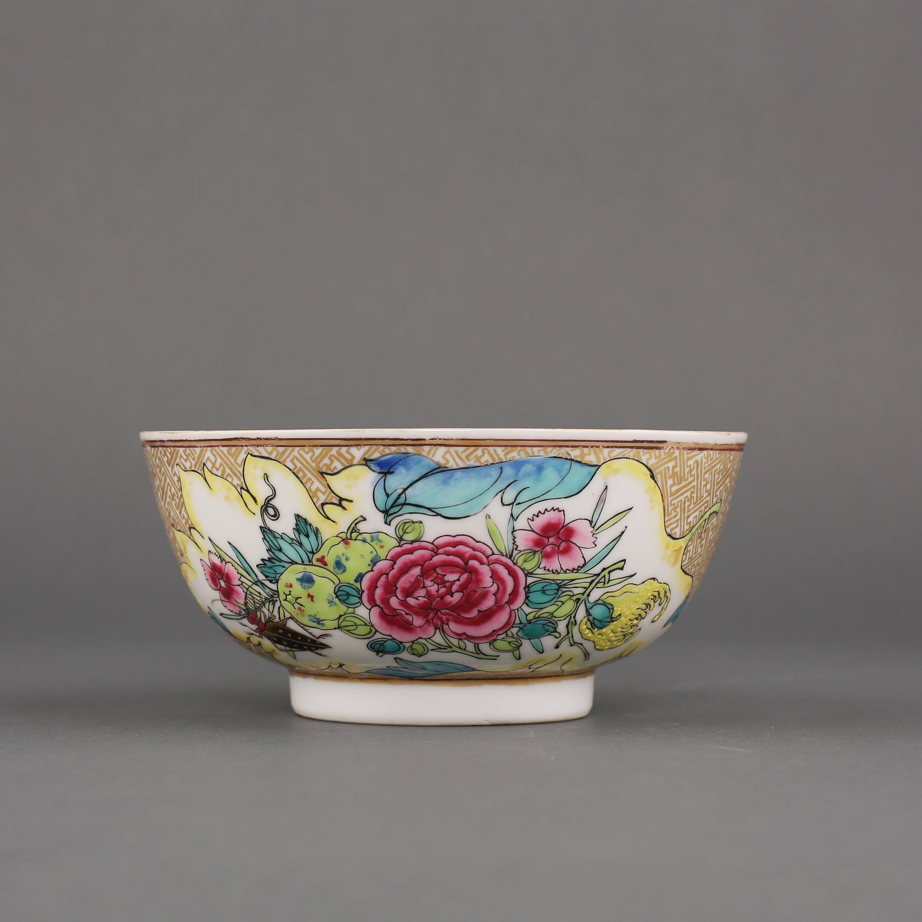Chinese porcelain semi egg shell famille rose small bowl painted with a cicada amongst two leaf shaped panels of peony, peach, finger citron and other flowers and leaves all on a gilt key fret ground, the interior painted with a single stylized
