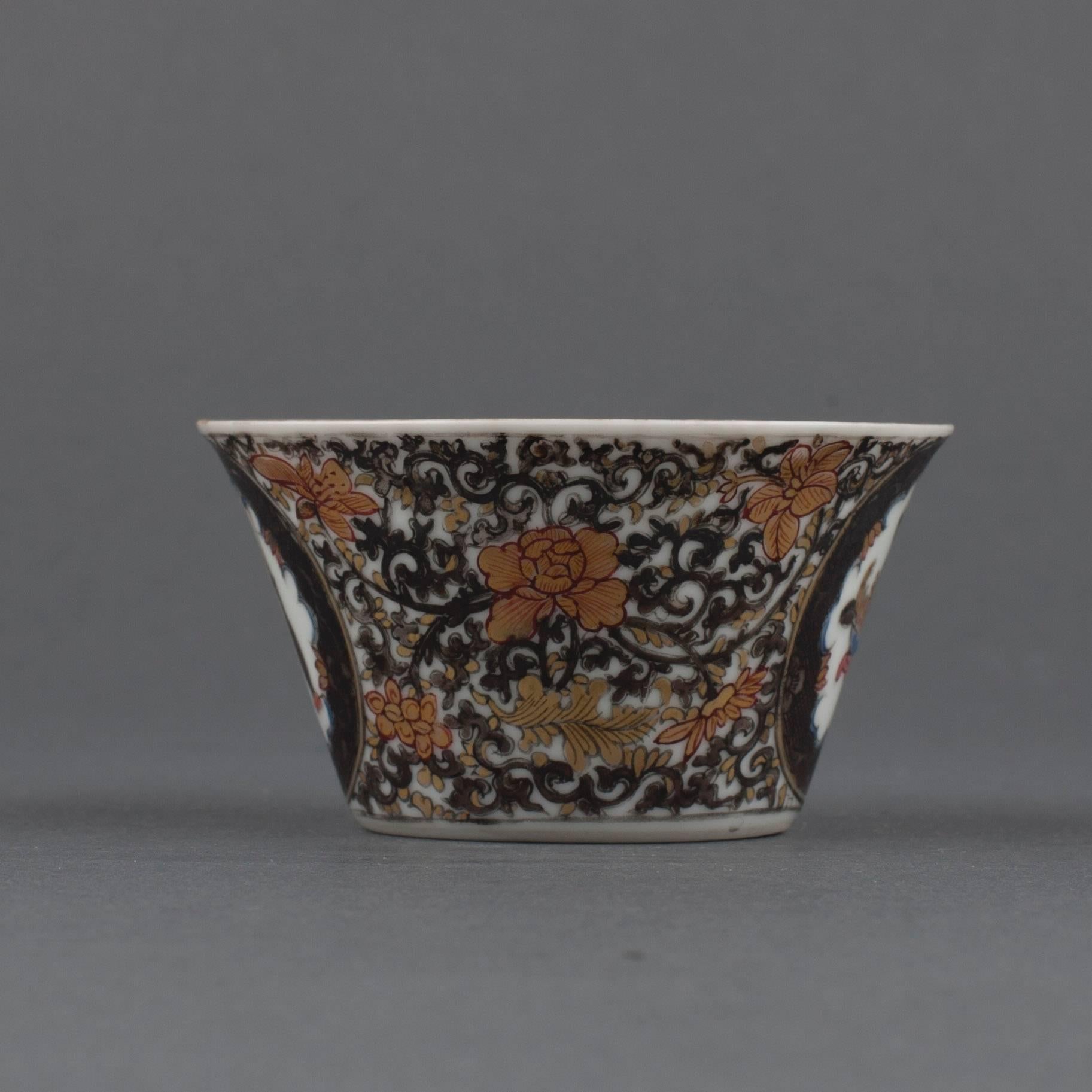 A Chinese porcelain semi-eggshell tea bowl of conical form, painted on the exterior in grisaille, gilt, blue and green enamels with two circular medallions enclosing an incense burner and vase, the reverse with a finger citron in a bowl beside a
