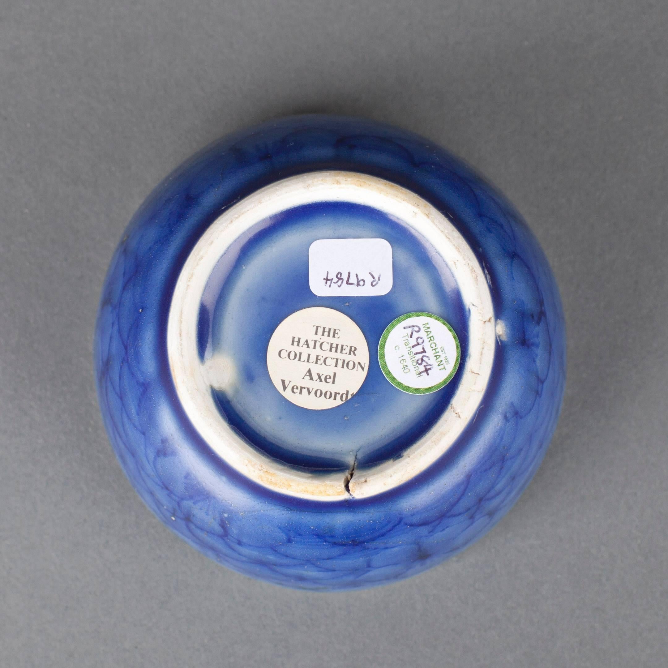 A Chinese porcelain blue glaze bowl and cover, the body painted on the exterior of the bowl with prunus blossom on a wave ground, the dome shaped cover similarly painted, the flat top knop unglazed.

Measures: Diameter 8.3 cm, 3 ¼