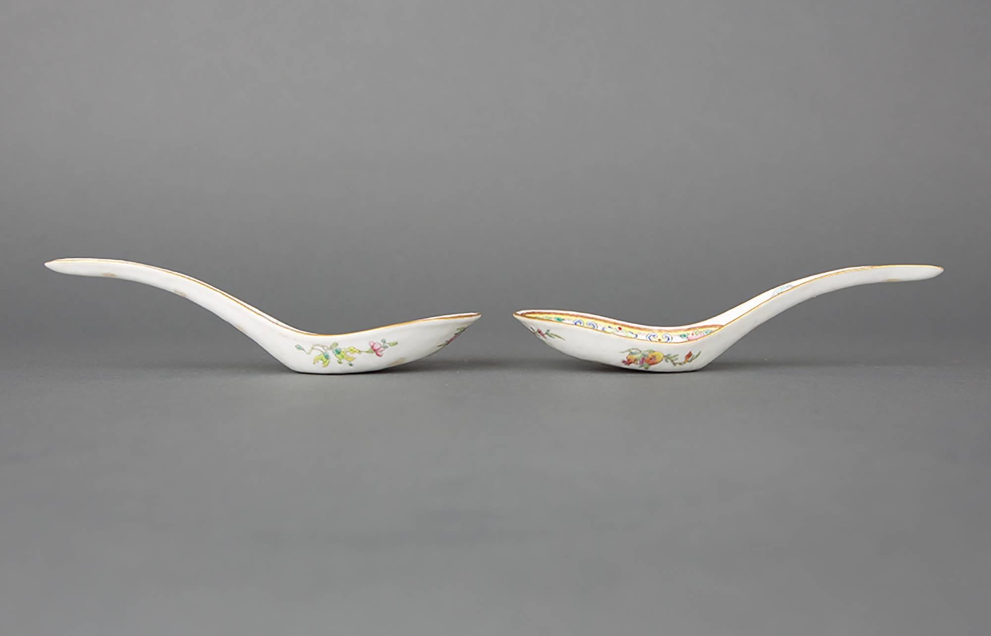 A pair of Chinese porcelain famille rose spoons painted with five bats, wu fu, three bats on the interior bowl of the spoon encircled by a decorative border with ruyi-heads and peach, the remaining two bats in the curved handle, the edges heightened