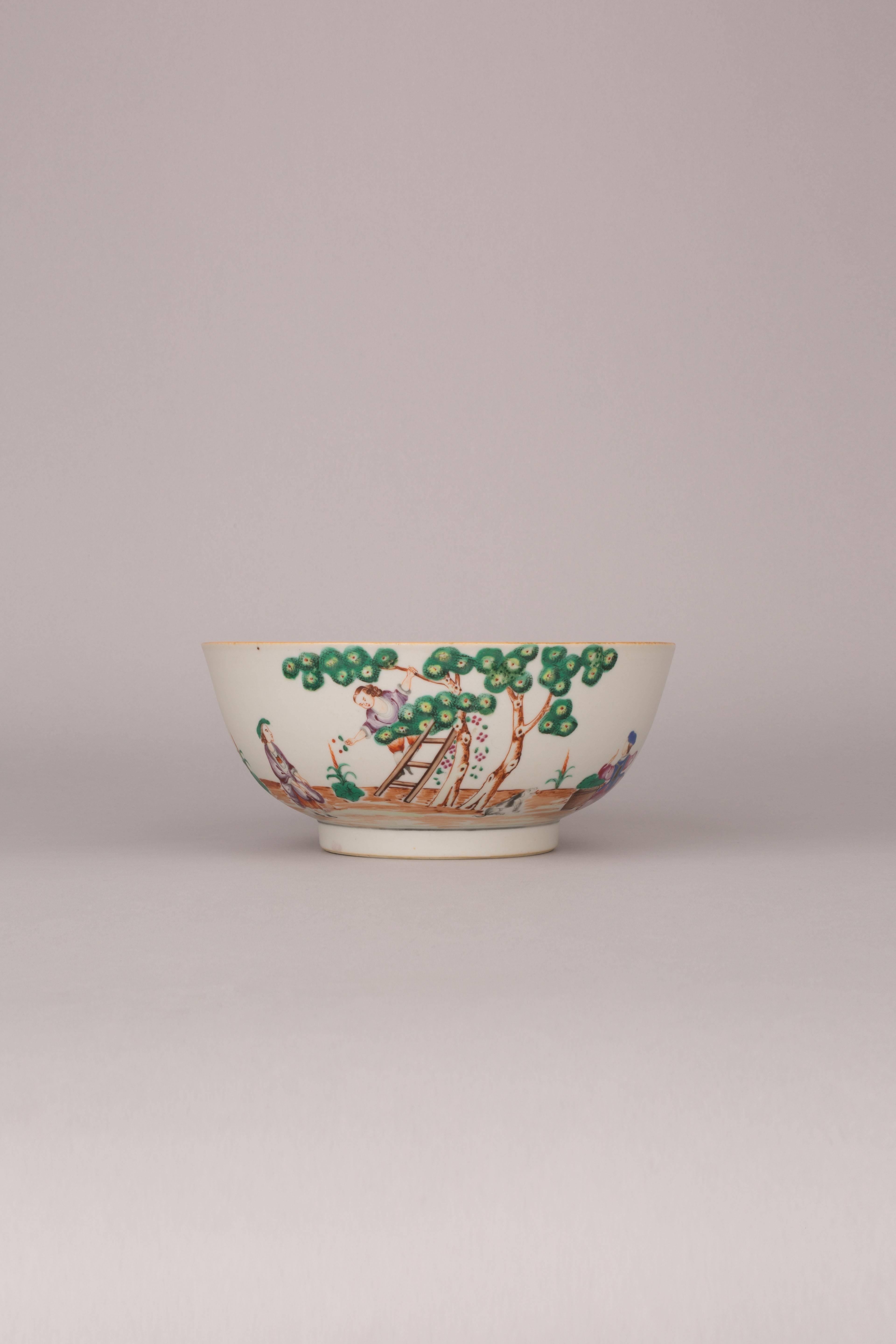 A Chinese export porcelain famille rose deep bowl, painted in a continuous scene with the ‘Cherry Pickers’, with a lady dressed as a boy climbing a ladder passing the cherries to a young man dressed as a woman collecting them in the front of his
