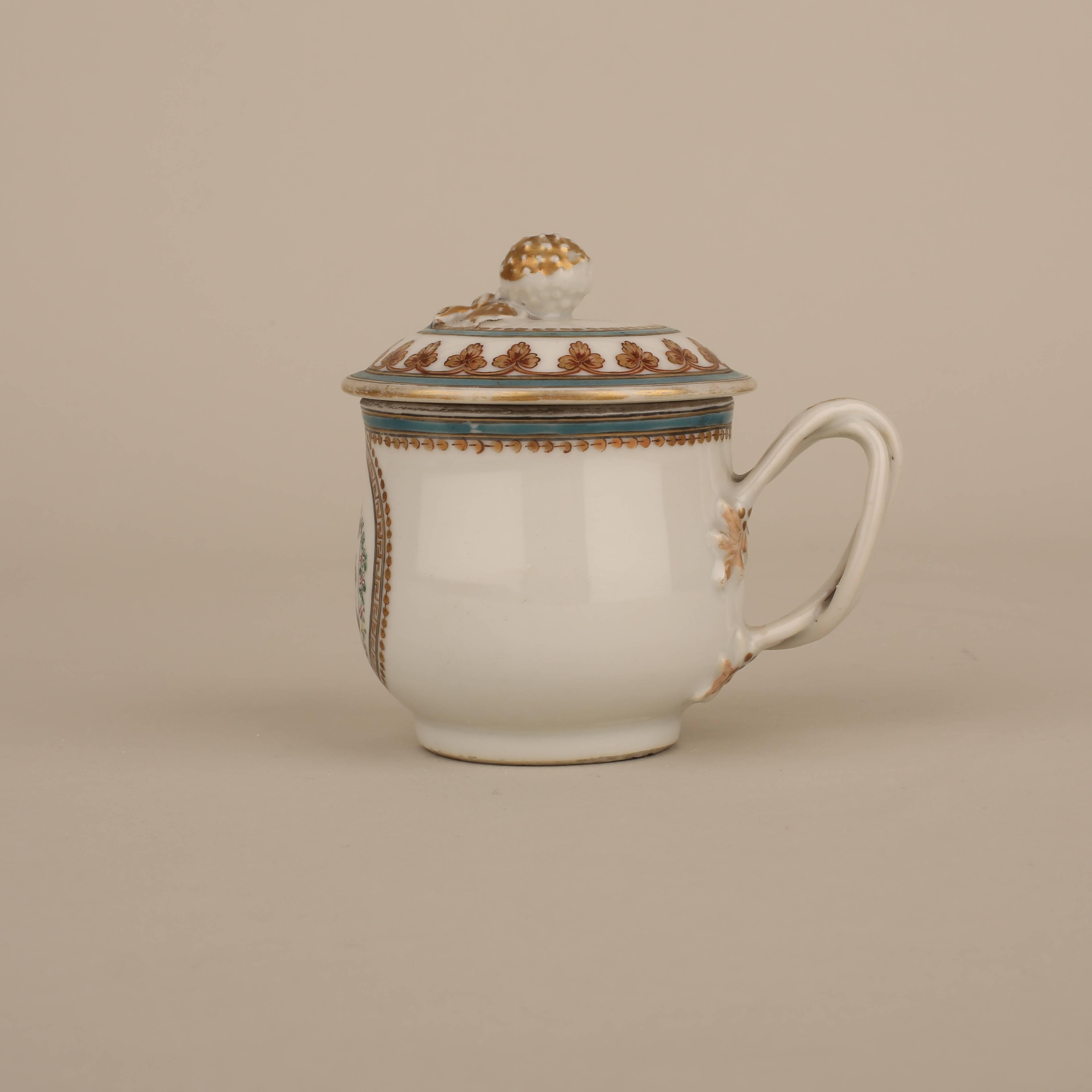 A Chinese porcelain slightly bulbous form Armorial cup and cover painted with a medallion containing a coat of Arms opposite the handle, the handle as two twisted branches beginning and ending in leaves, the rim with a gold and blue continuous band,