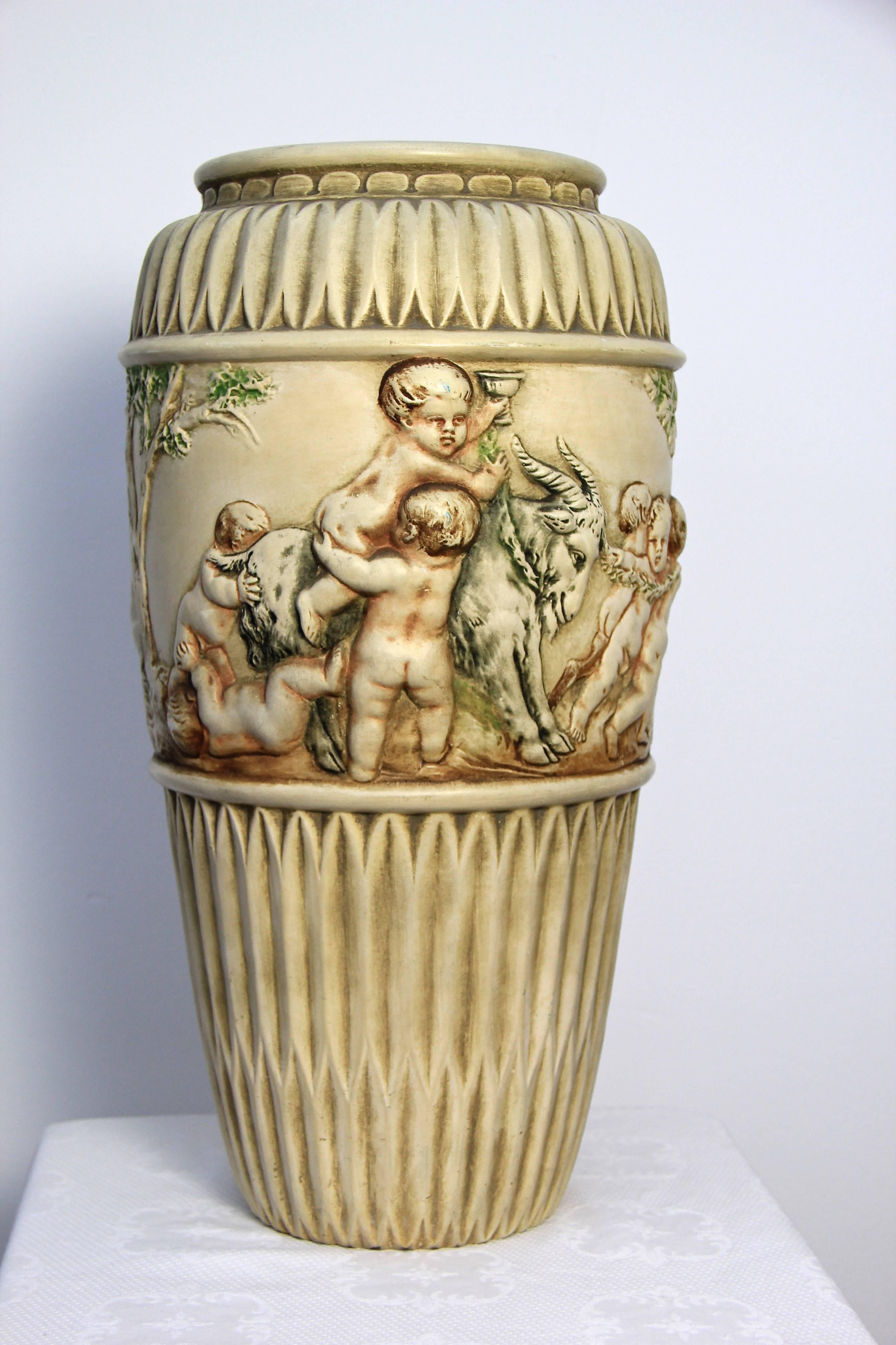 Have a look at this timeless ceramic vase from the Johann Maresch manufacture, a famous ceramic company in the old danube monarchy - from Bohemia (now Czech republic).
This piece shows a wonderful handpainted ongoing relief work with playing kids,