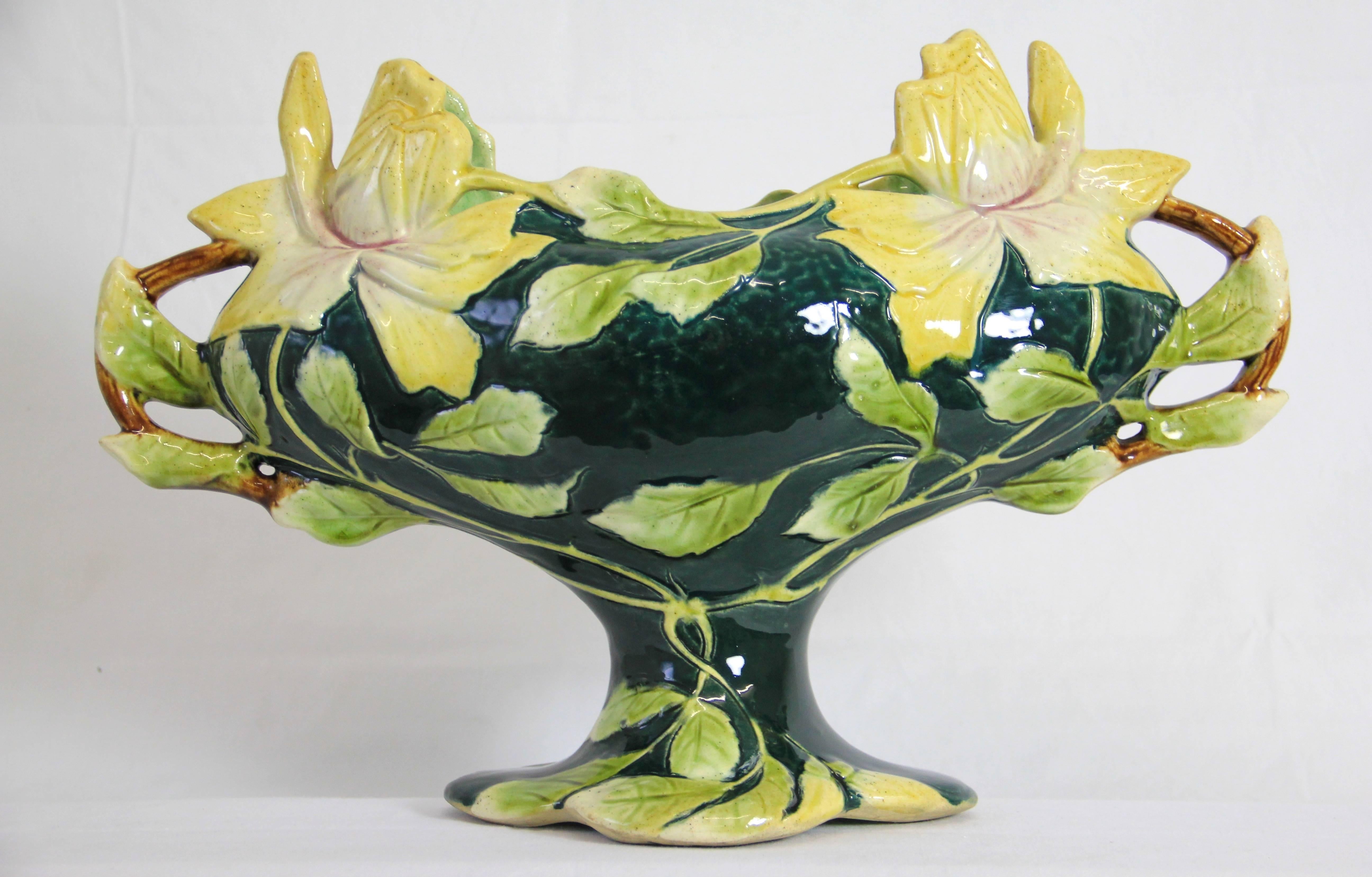 The wonderful Jardiniere shows a beautiful floral design very typical for the Art Nouveau era. The colors from dark green to light green alongside the perfect worked leafs and yellow blossoms definitely makes this piece an amazing eye-catcher.
On