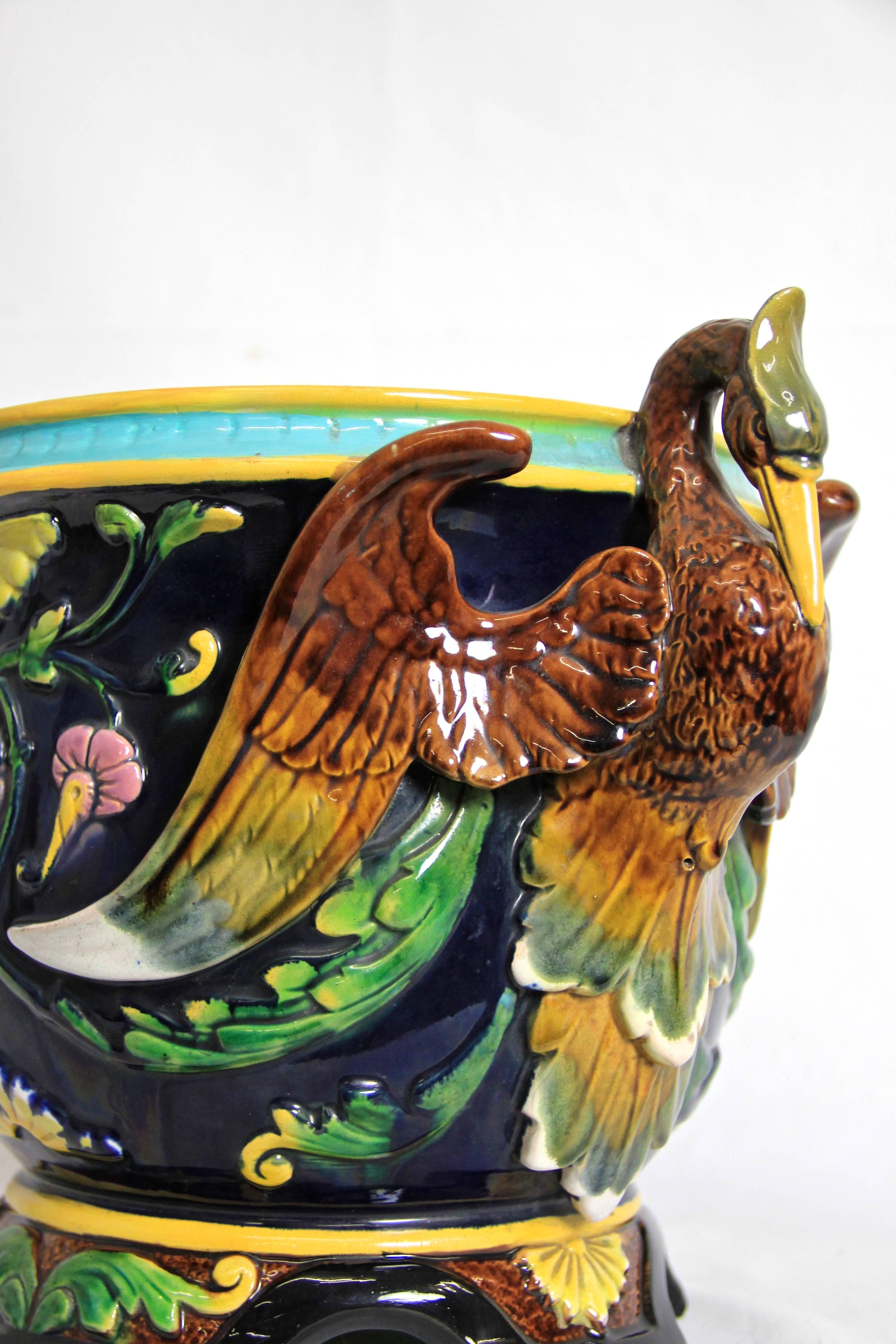 Surrounded by two majestic cranes, this Classic floral designed Art Nouveau cachepot comes from the world famous manufacture of "Wilhelm Schiller & Söhne" from the Czech Republic (at this time still "AUSTRIA"), circa