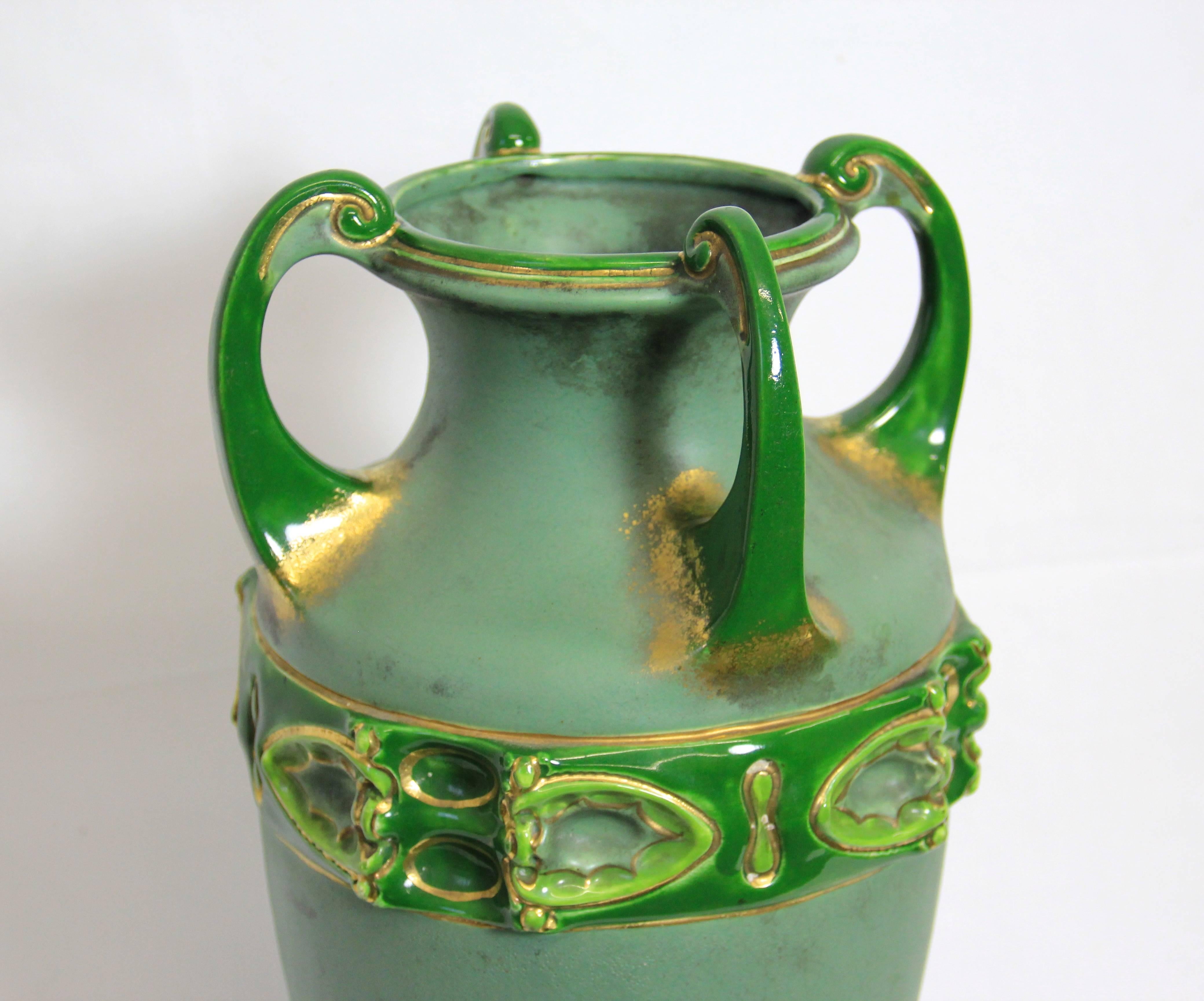 This Outstanding Amphora Vase is an absloute classical piece of the Art Nouveau era. The beautiful organic design, the amazing green tones and the golden accents are simply stunning. Manufactured was this vase by the famous austrian company 