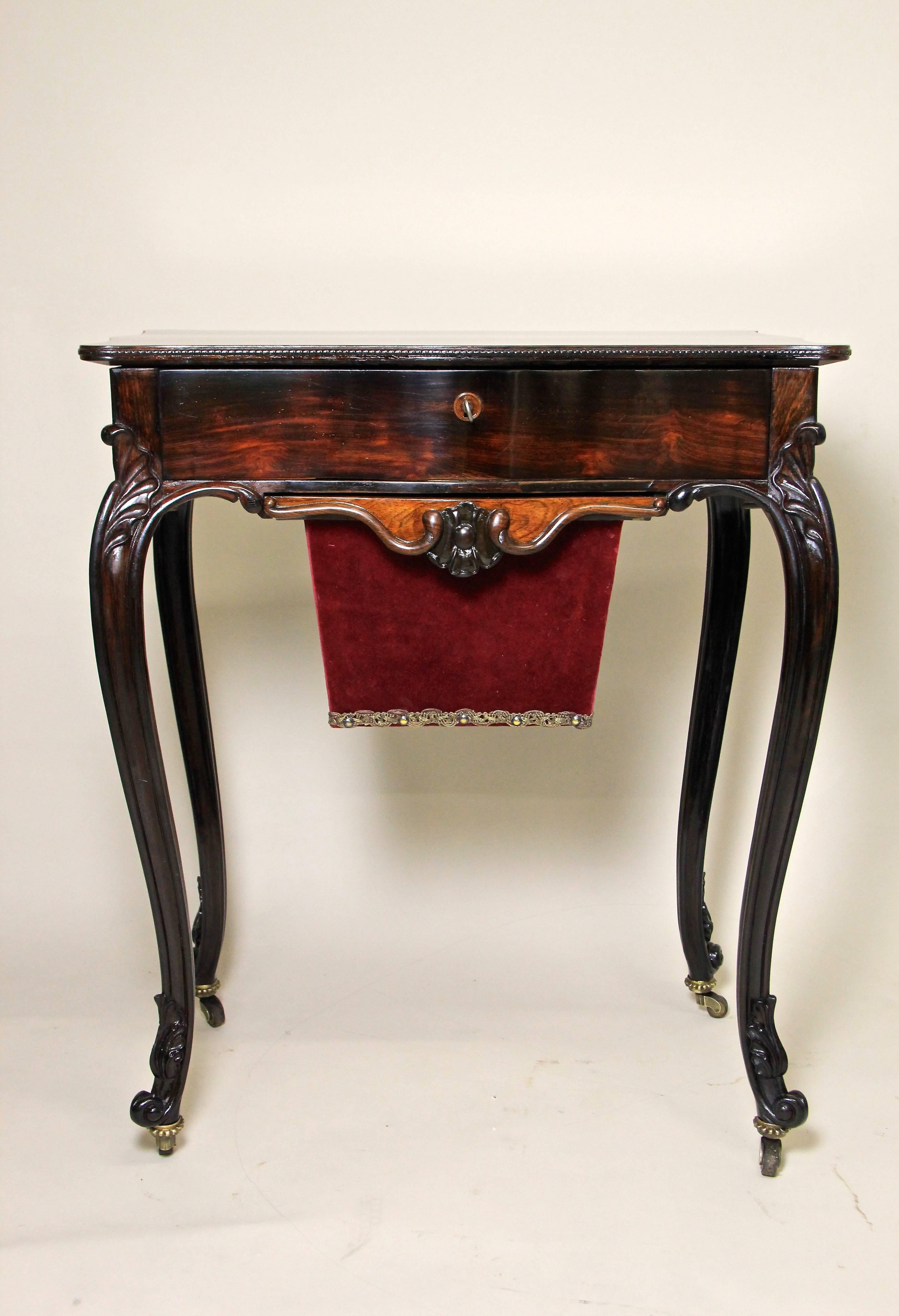 Absolute Gorgeous Louis Philippe side table or sewing table from around 1870. The beautiful carved delicate solid nut wood table legs combined with the amazing veneer work makes this table an absolute eye-catcher. The main drawer consists of six
