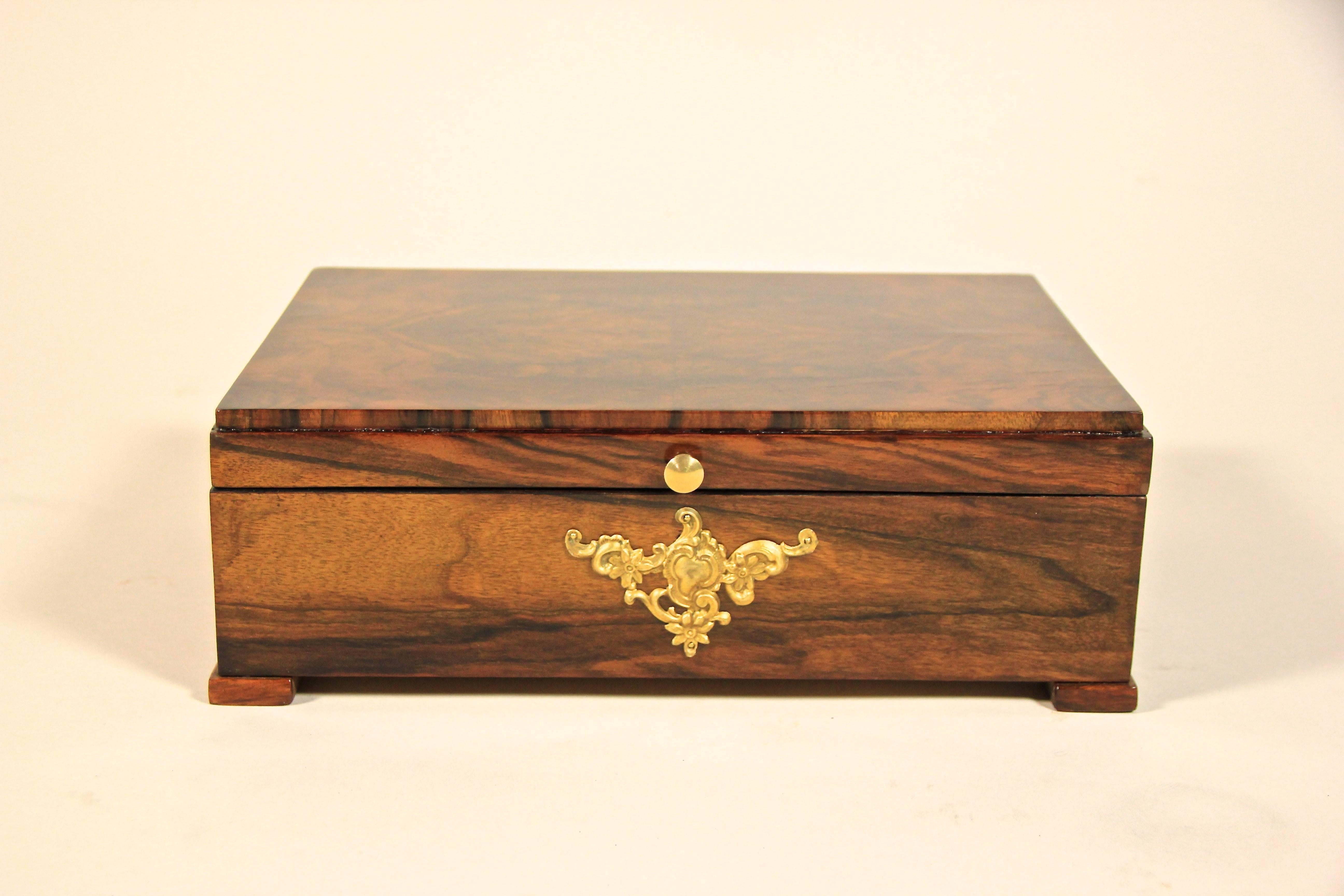 Dreamlike wooden box from the early Austrian Art Nouveau era, circa 1900. Showing an amazing veneer work with mirror matched walnut wood on top - this decorative box with a removable compartment can be used for many things. The ornate shaped brass