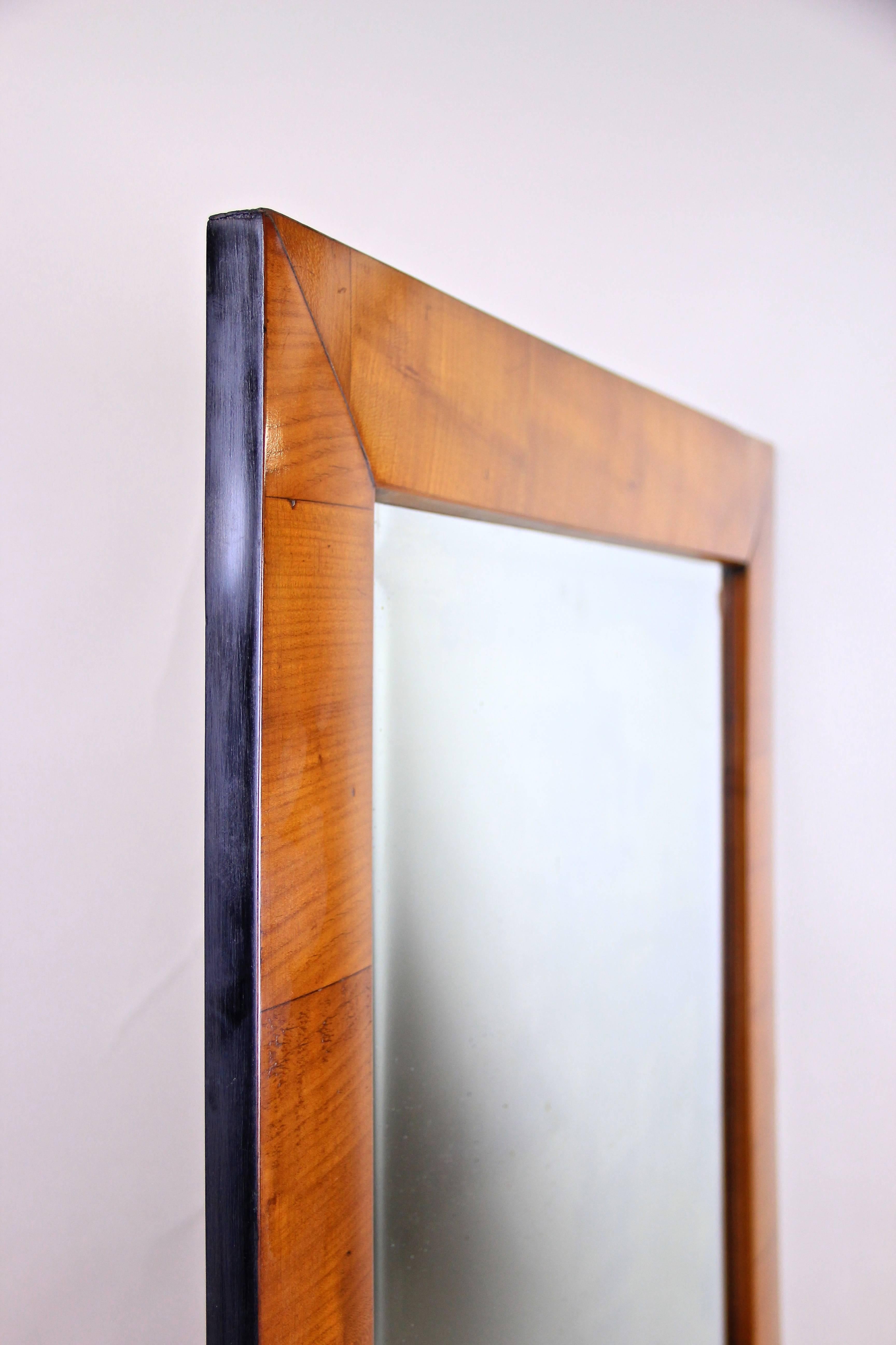 A magnificent Biedermeier Wall Mirror dating to circa 1830 during the early Biedermeier period in South Germany. This beautiful rectangular mirror has an substructure where the connections were made in an old technique called 