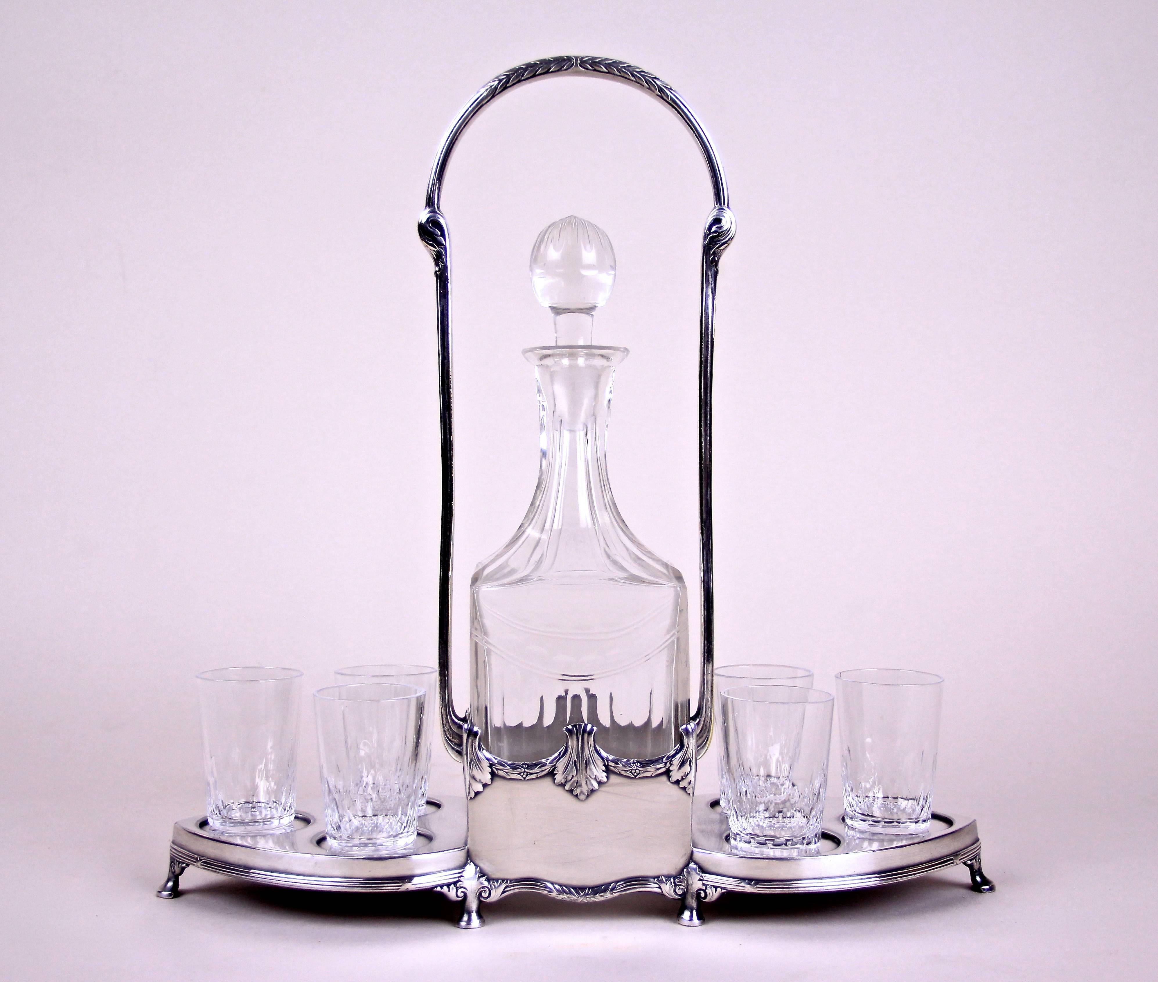 Exclusive Art Nouveau liquor set by WMF from Germany, circa 1910. This amazing set consists of six beautiful cut glasses and a quadrangular glass bottle. The whole glassware is arranged on a beautiful designed silvered metal stand with typical Art