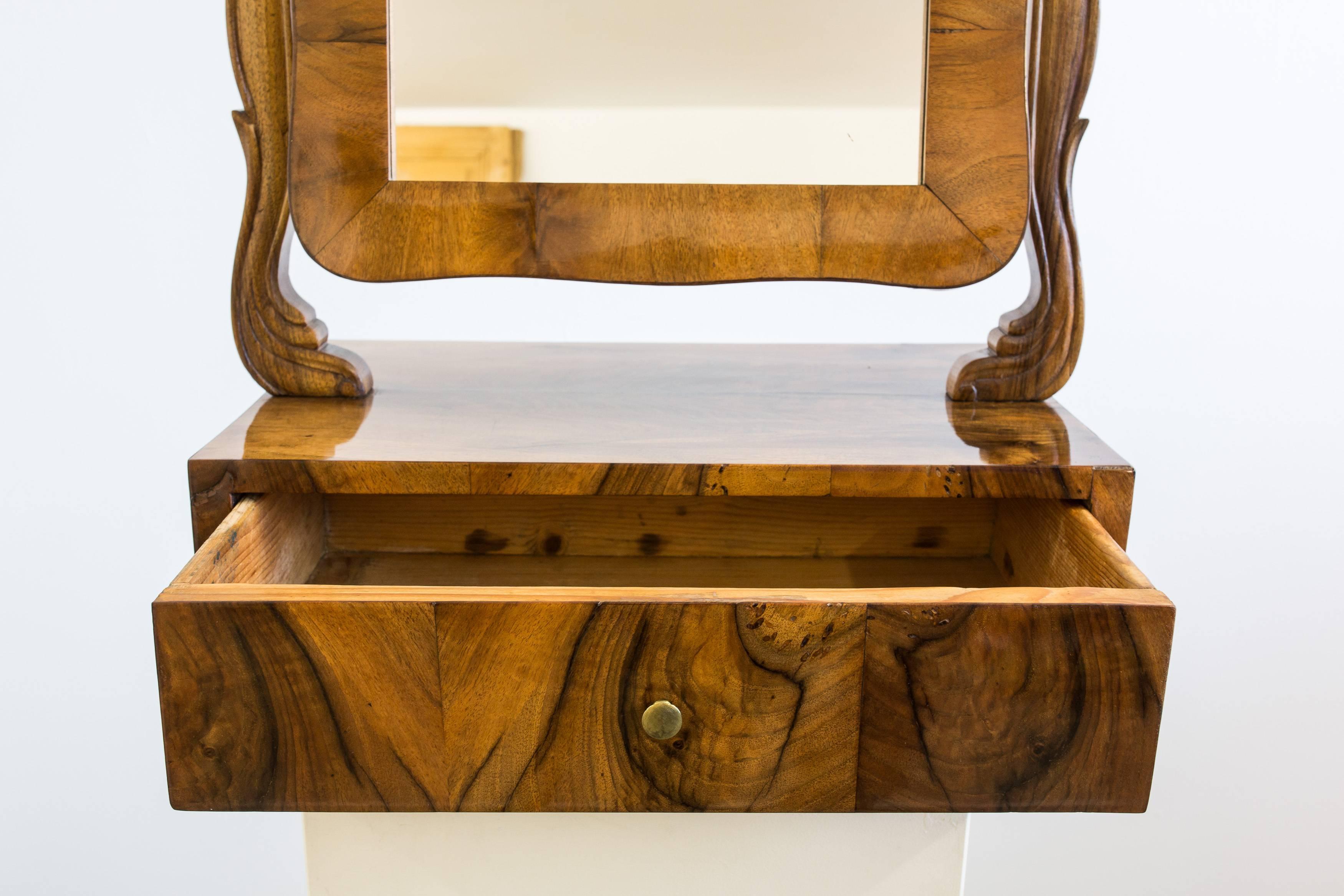 Decorative vanity mirror or box from the Czech Republic circa 1840, walnut veneered with a hand-polished shellac finish. The mirror, floating between two carved (fan decored) pillars was renewed during the restoration process and can be vertically