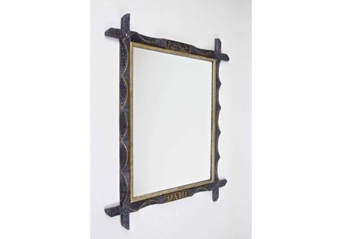 Peerless rustic wooden wall mirror from Austria, dated to 1901. A very special designed wall mirror with a golden bar on the inside and slightly protruding corners. Artfully handcarved out of basswood, this unique frame impresses with its