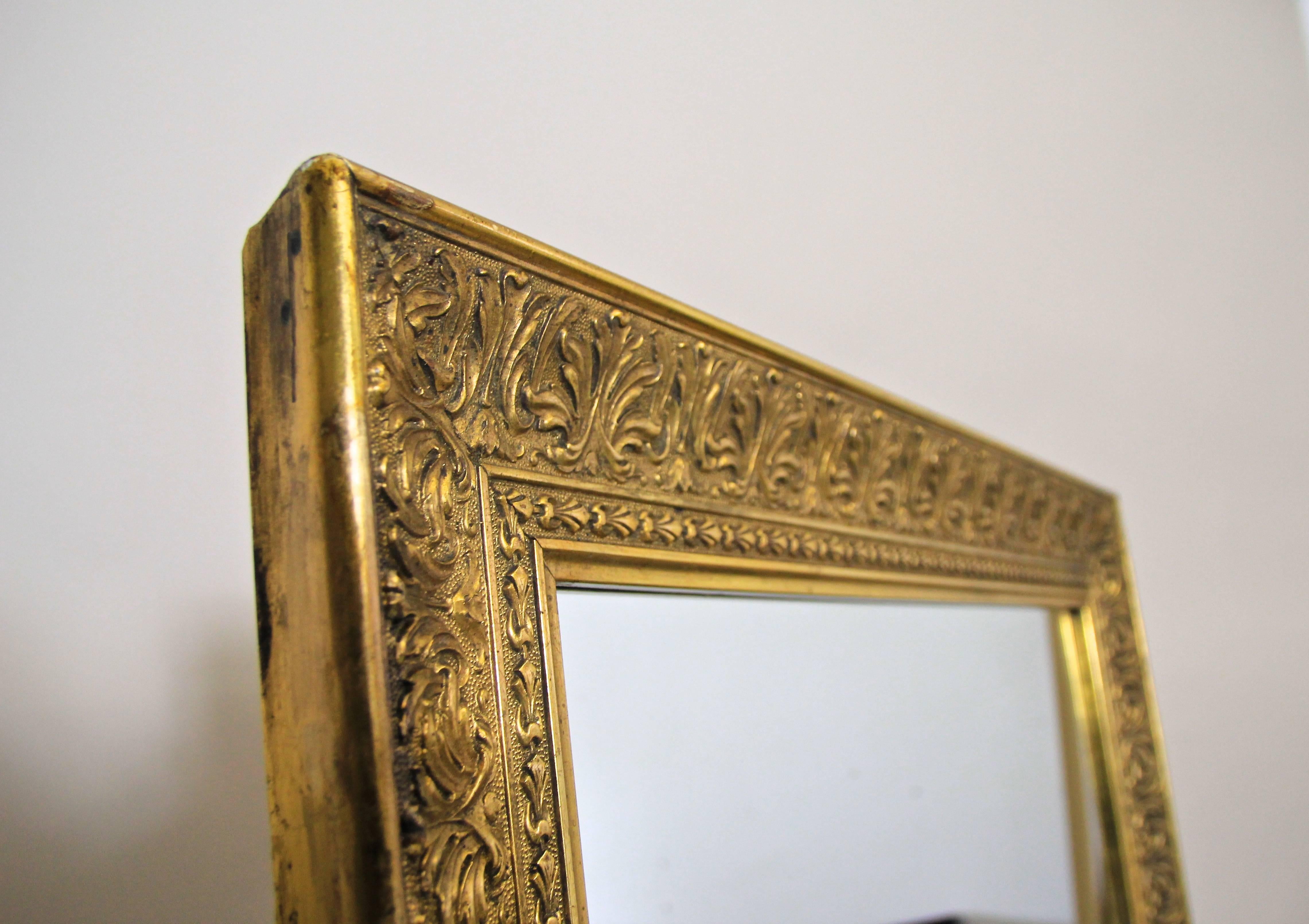 Elegant large golden mirror from Austria made in the early days of the 20th century. The golden frame is covered with Fine composition gold and is richly decorated with beautiful stucco leaf tendrils.
A real eye-catching piece with a nice unique