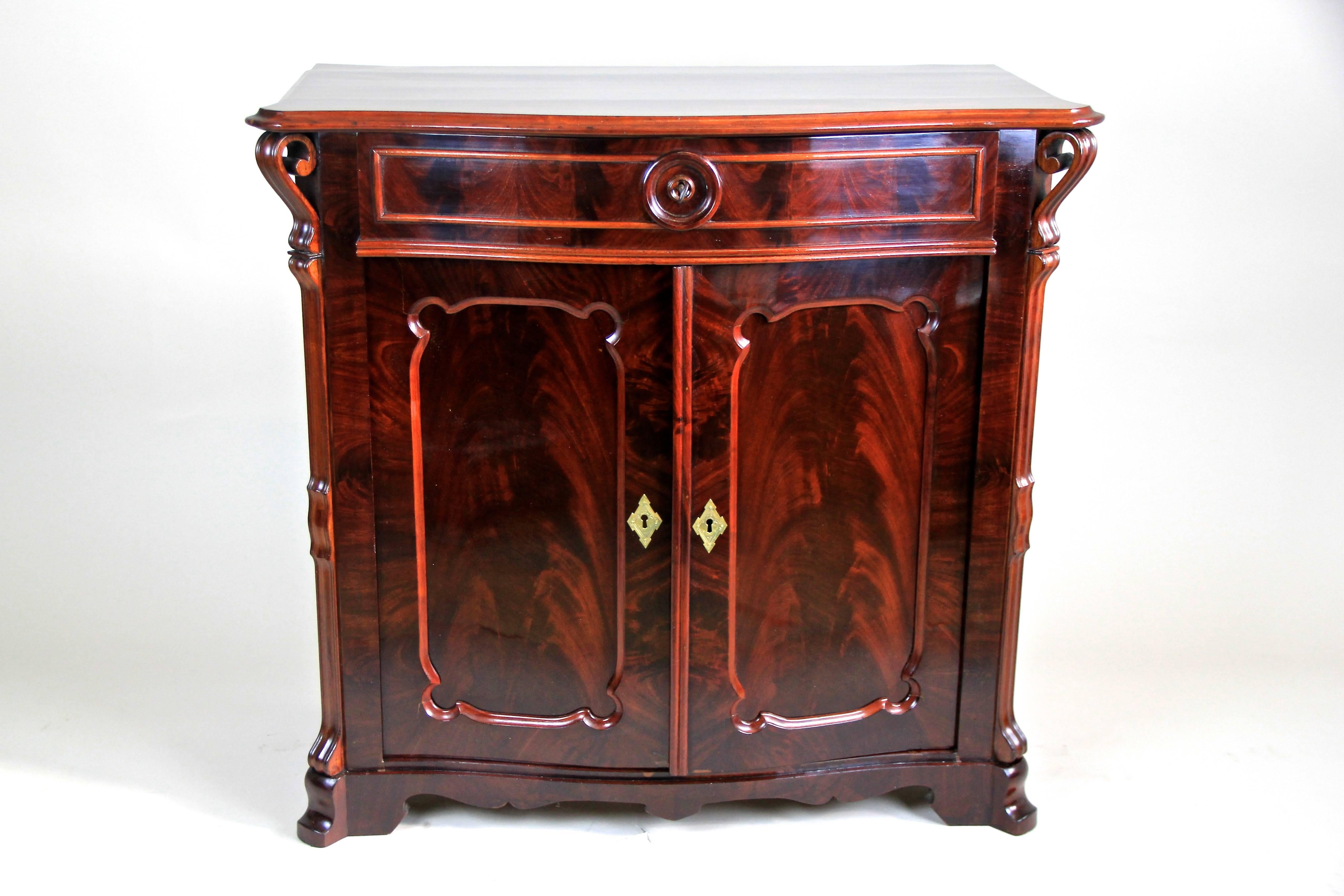 Brand new in our collection we offer you this outstanding Louis Philippe Trumeau commode made out of finest mahogany veneer. This compact Austrian Trumeau from the Louis Phillippe era around 1865 shows amazing hand-carved applications and an amazing