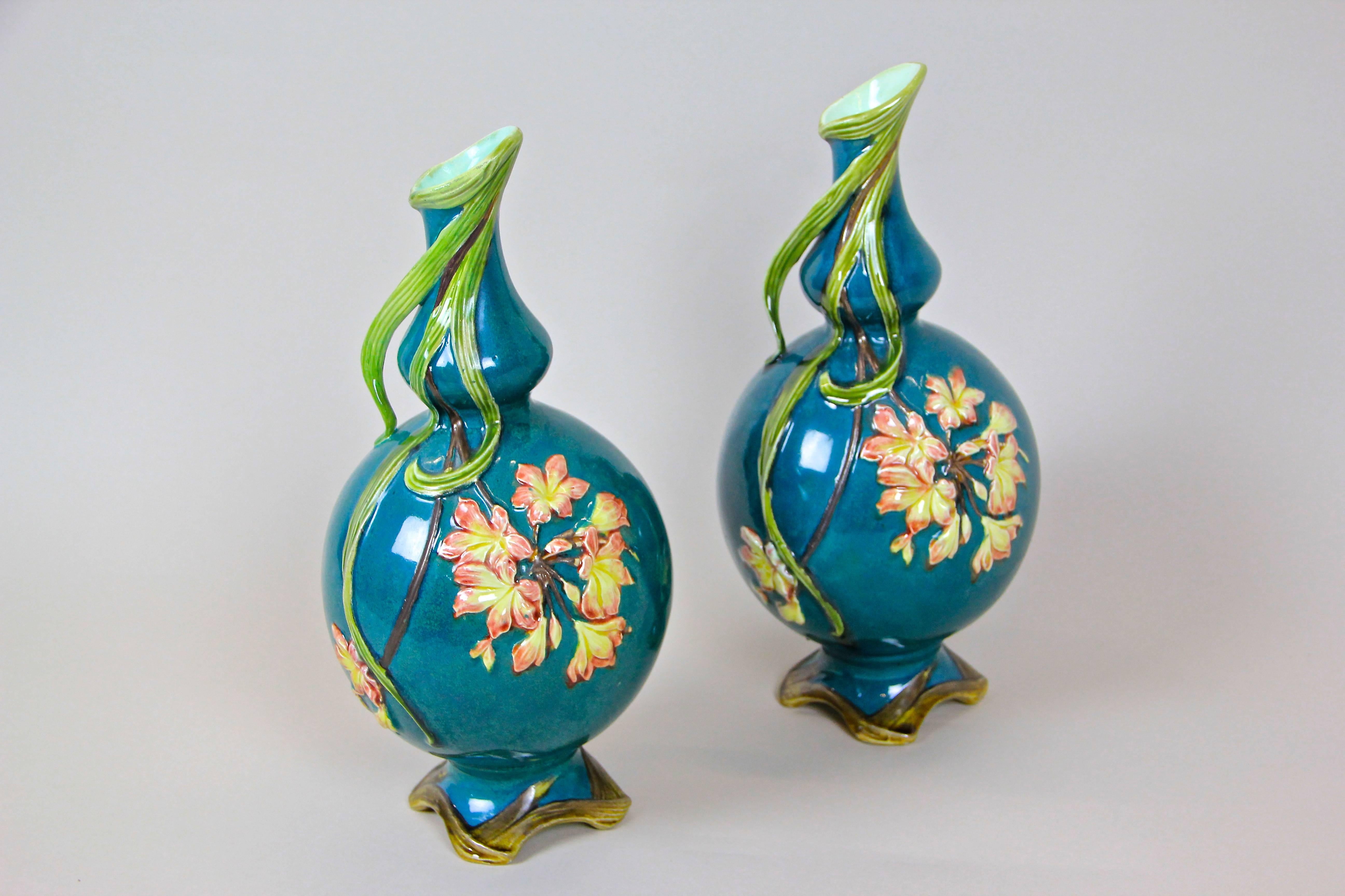 Coming from France circa 1910 we present to you this outstanding pair of beautiful designed Art Nouveau vases. The great floral design combined with an unique hand-painted coloring makes this pair a super decorative combo. Pretty flowers in light