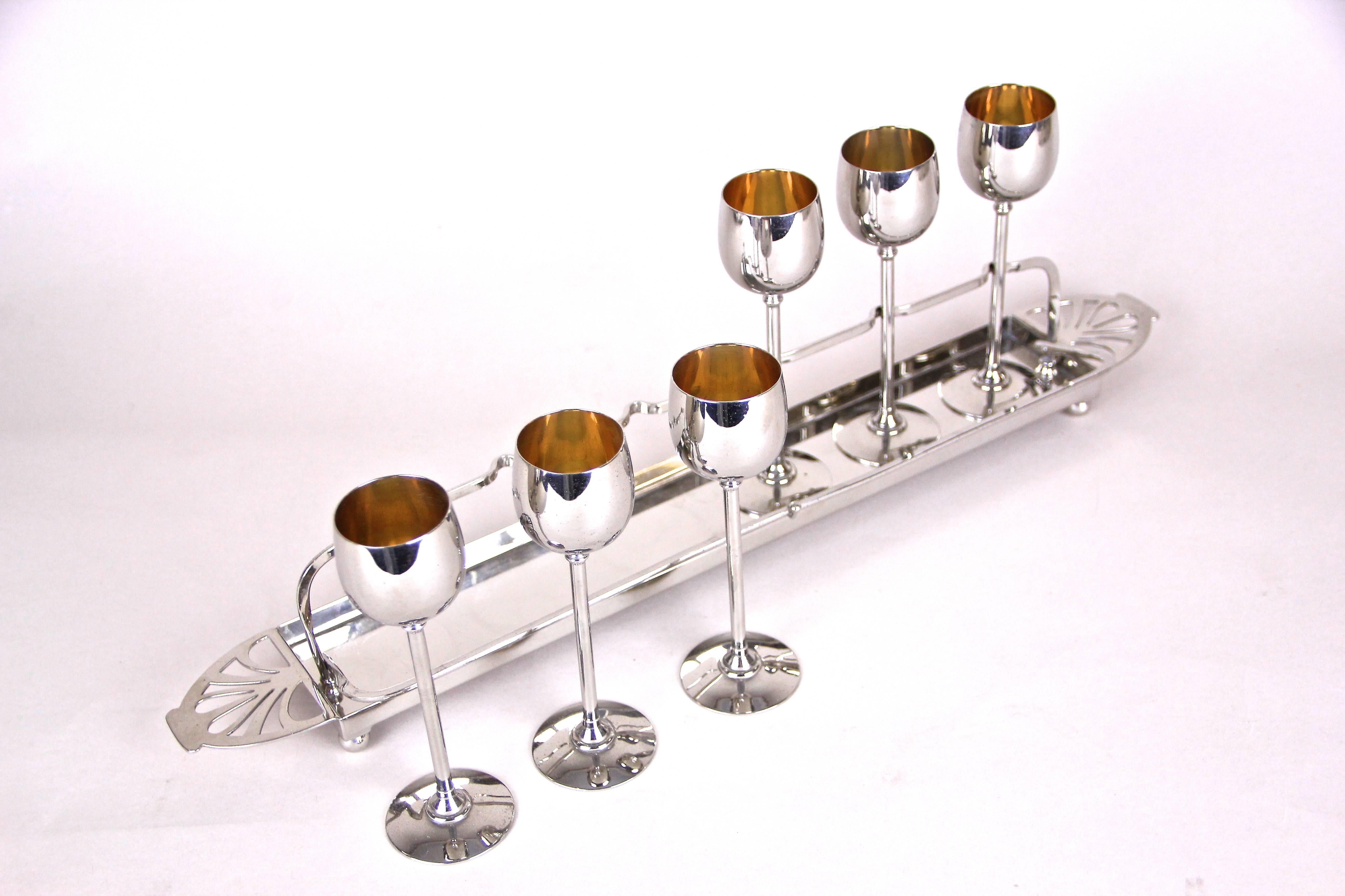 Exceptional Art Nouveau liquor glasses by WMF from Germany. From circa 1910, this marvelous set consists of six glasses that Stand on a great designed slender nickel plated metal stand saved with an unique clasp, like the one that are well-known