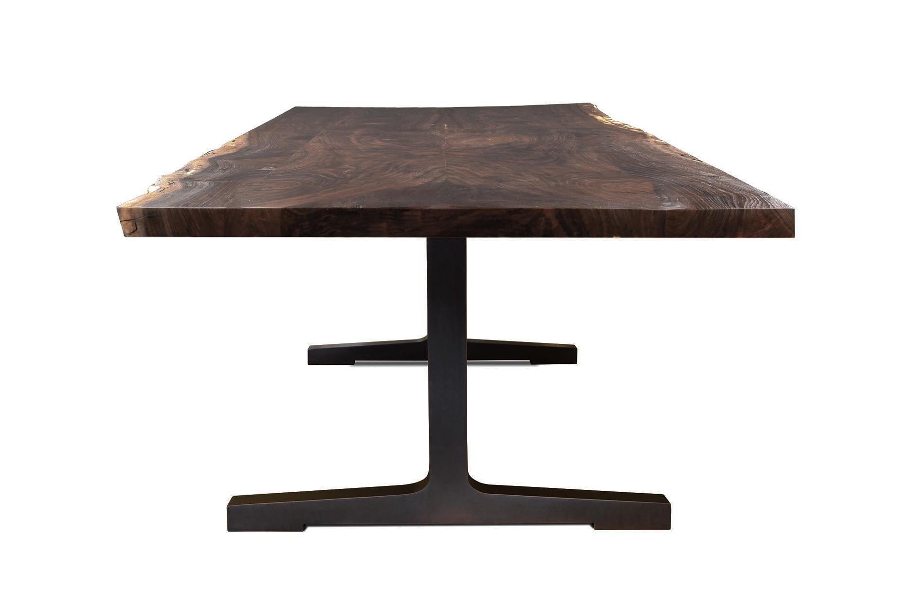 The Soho dining table captures the essence of Studio Roeper's signature style: the warm, organic nature of the walnut slab top matched with clean, contemporary lines of the blackened steel legs. This design is versatile in it's ability to blend into