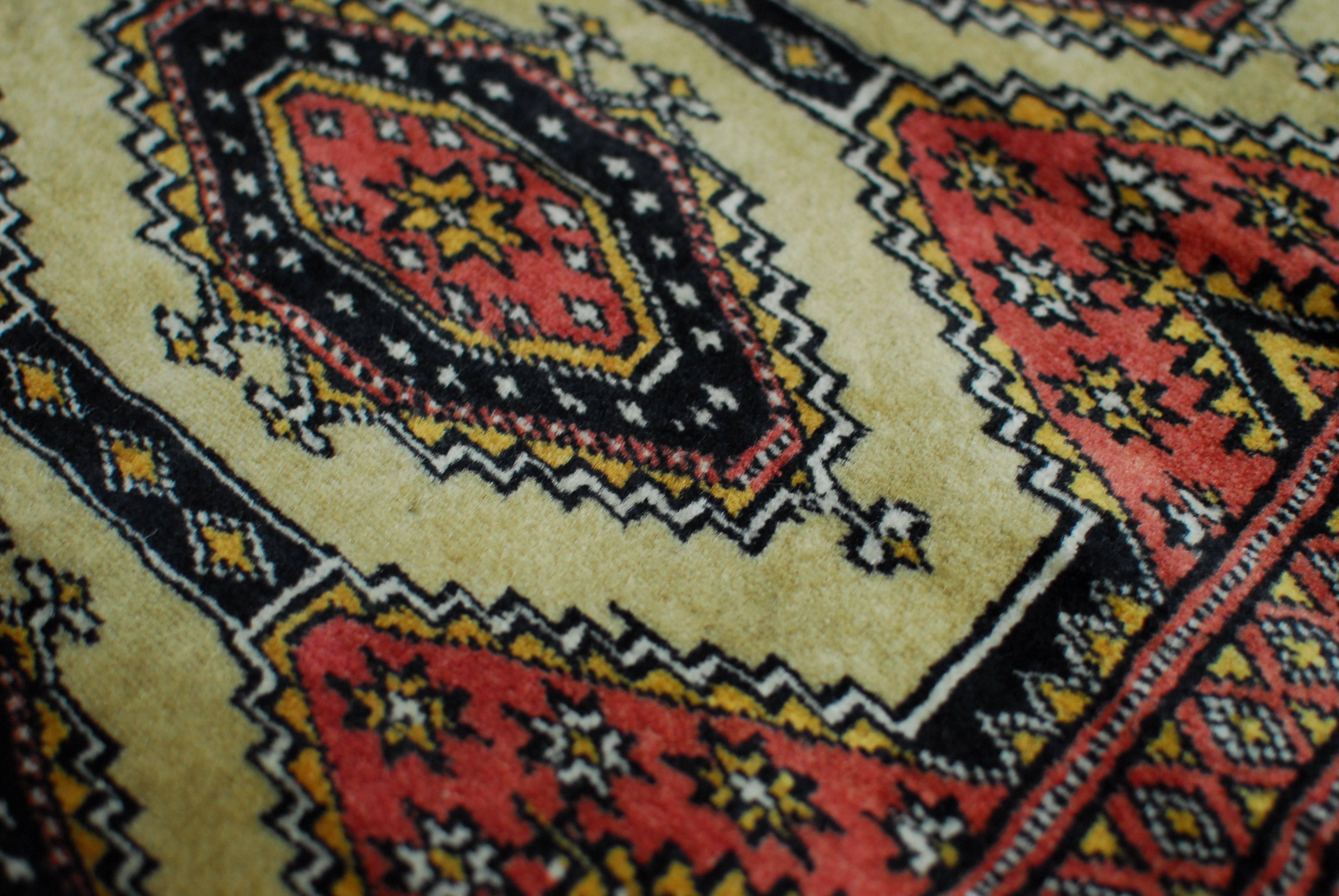 Exquisite Pakistani Bokara carpet woven with a high knot density and intricate geometric patterns over a rare black background. Low pile with a very soft velvety feel.

