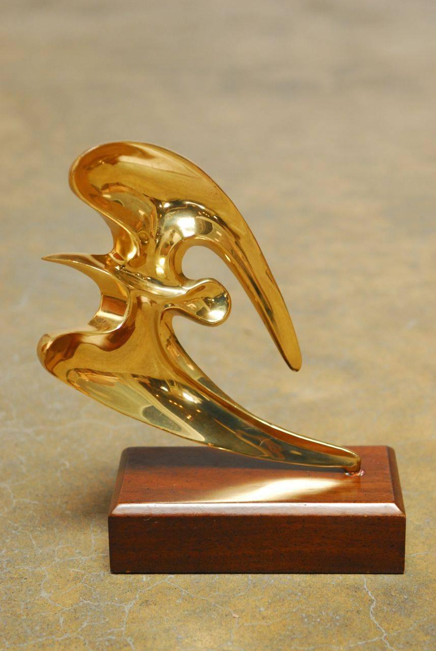 Polished brass sculpture of a seagull mounted on a wooden stand. Made in the manner of Bob Bennett. Beautiful movement viewed from either side.
