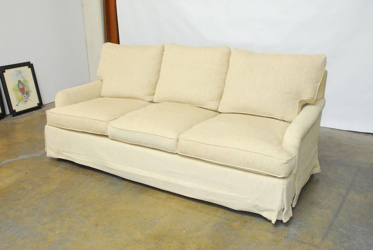 Classic English rolled arm sofa custom ordered from an upholstery shop in San Francisco. Features a soft, natural chenille fabric with a skirted frame. High quality craftsmanship with a strong solid frame. Deep, generous construction with thick