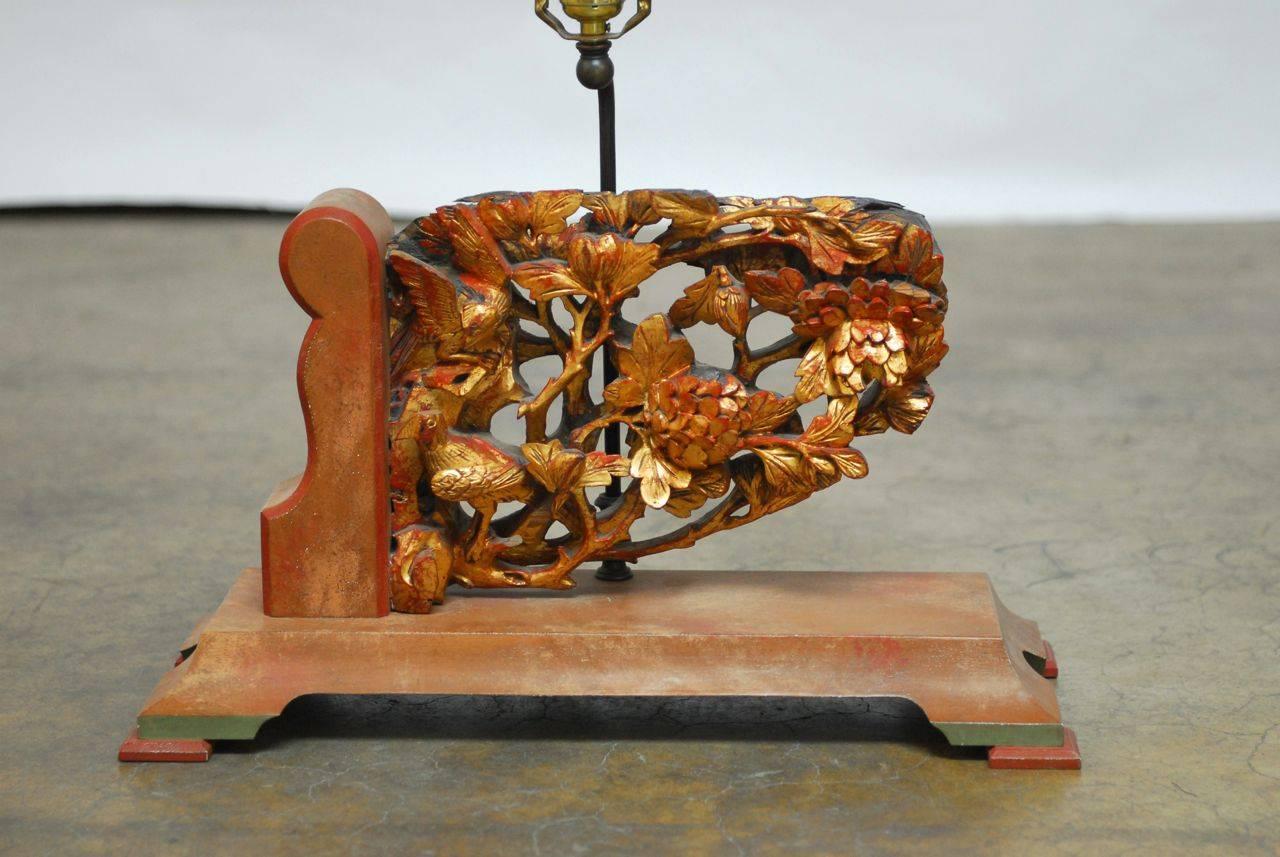 Lovely Chinese temple carving architectural fragment that has been mounted as a table lamp. Intricate carving of birds and chrysanthemums decorated with red lacquer and gilt. A custom mount has been created to hold the carving decorated with