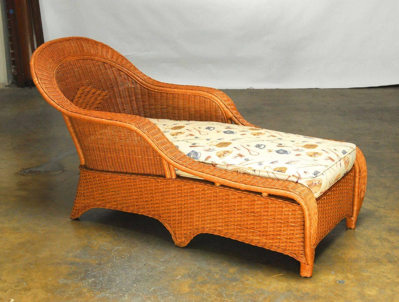 Fine French style woven rattan, bamboo and wicker chaise longue produced by Palecek of San Francisco, CA. Graceful sloping arms are contrasted by the woven Art Deco style geometric accented seat. The bamboo frame is covered by beautiful sheets of