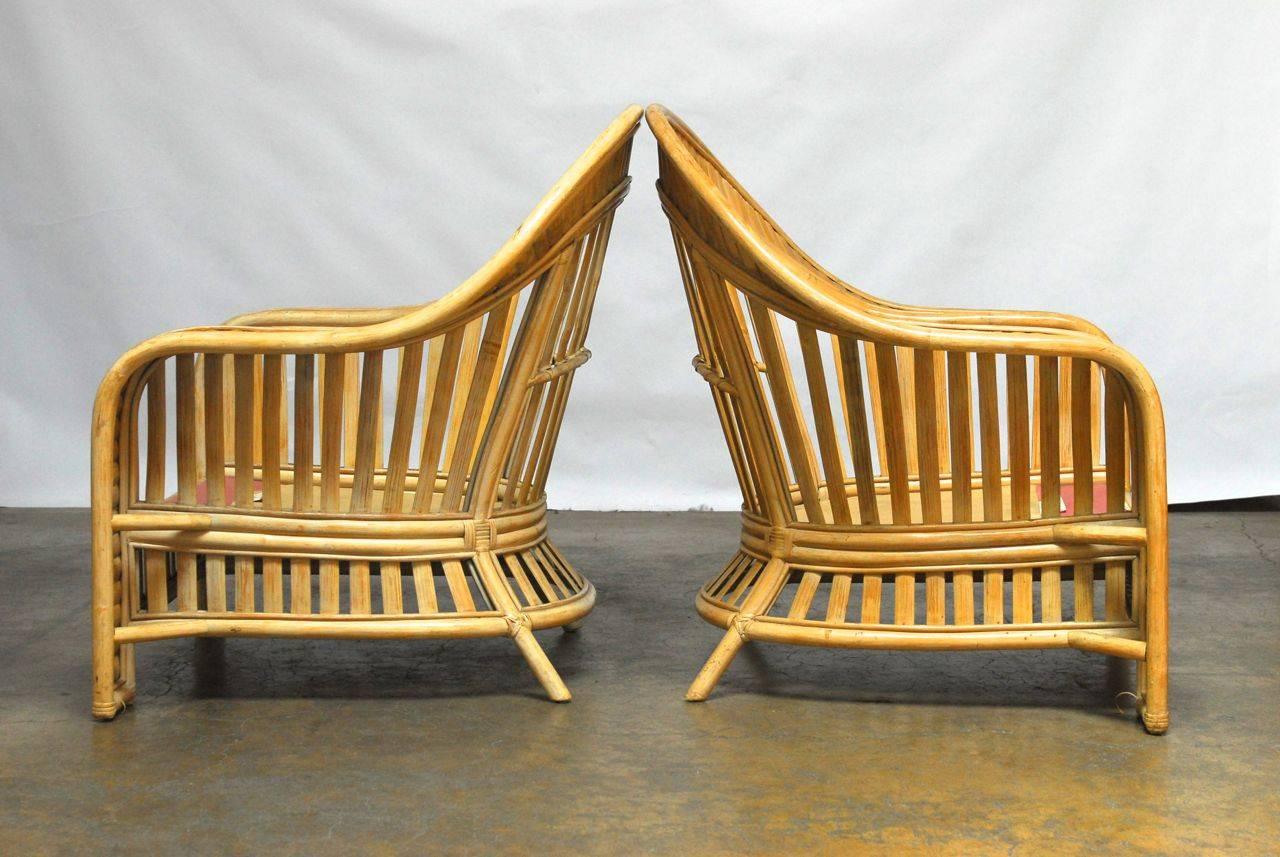 Fabulous pair of whitewashed split bamboo and rattan armchairs featuring a dramatic fan back style. Wide banded arms with bamboo slat back and apron. Produced by O-Asian of California, the producer of the Ralph Lauren rattan collection. Fine quality
