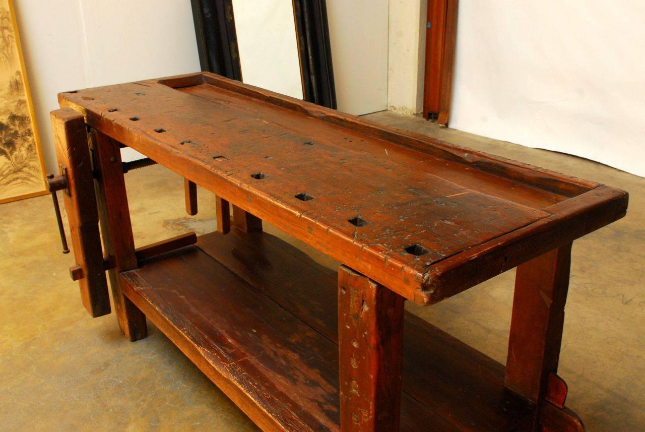 Exceptional Etabli de Menusier made of richly patinated elmwood with gorgeous split wood construction. This carpenters work bench is an impeccable example of both rustic and early industrial furniture. Built by the carpenter with dowels and rare