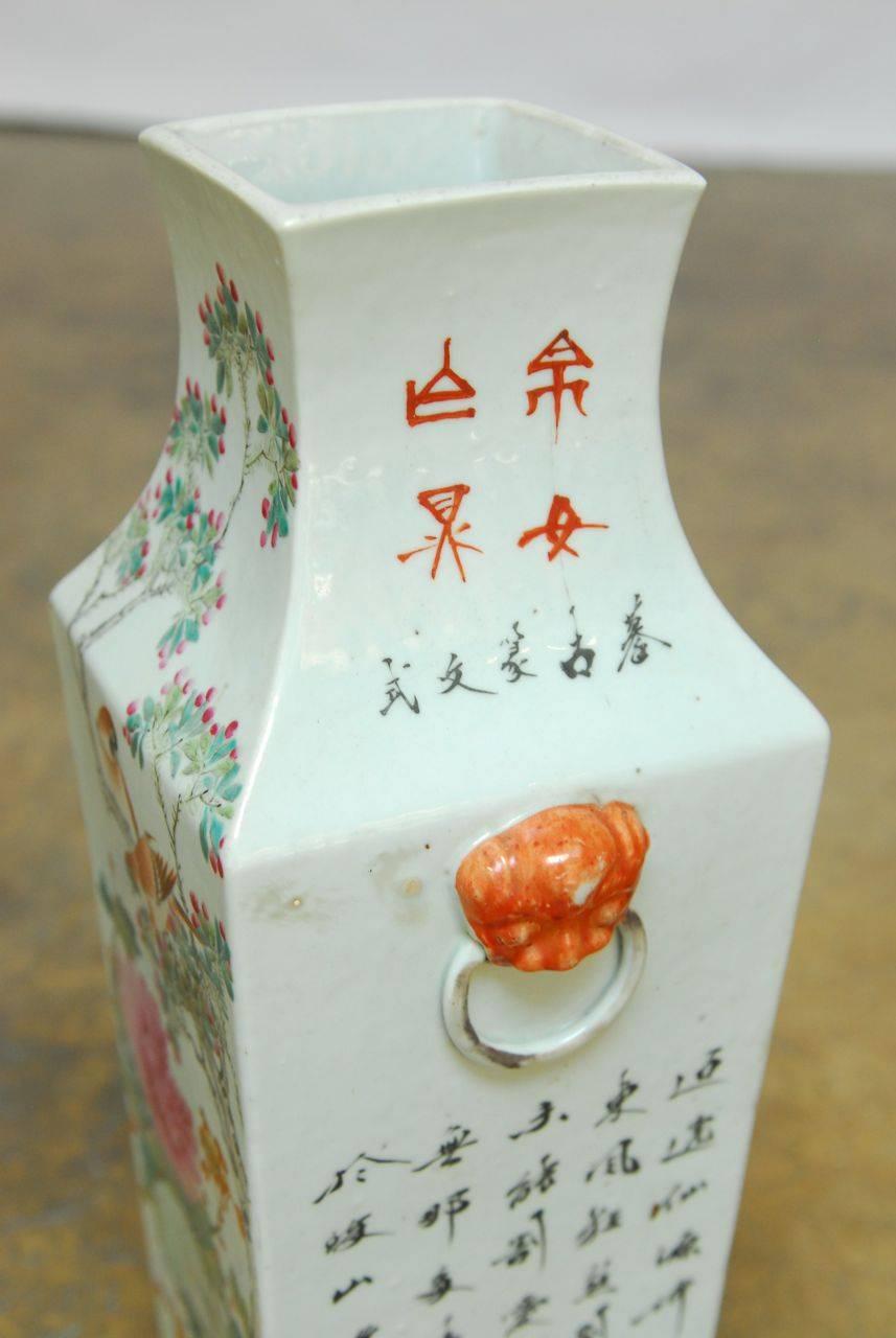 Beautiful Chinese enamel hand-painted porcelain vase from the Republic period made in the Qing style with apocrophycal mark. Features calligraphic inscriptions with a garden motif of birds and flowers. Foo dog guardian lion handles on each side.