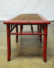 Banc en canne en faux bambou laqué rouge